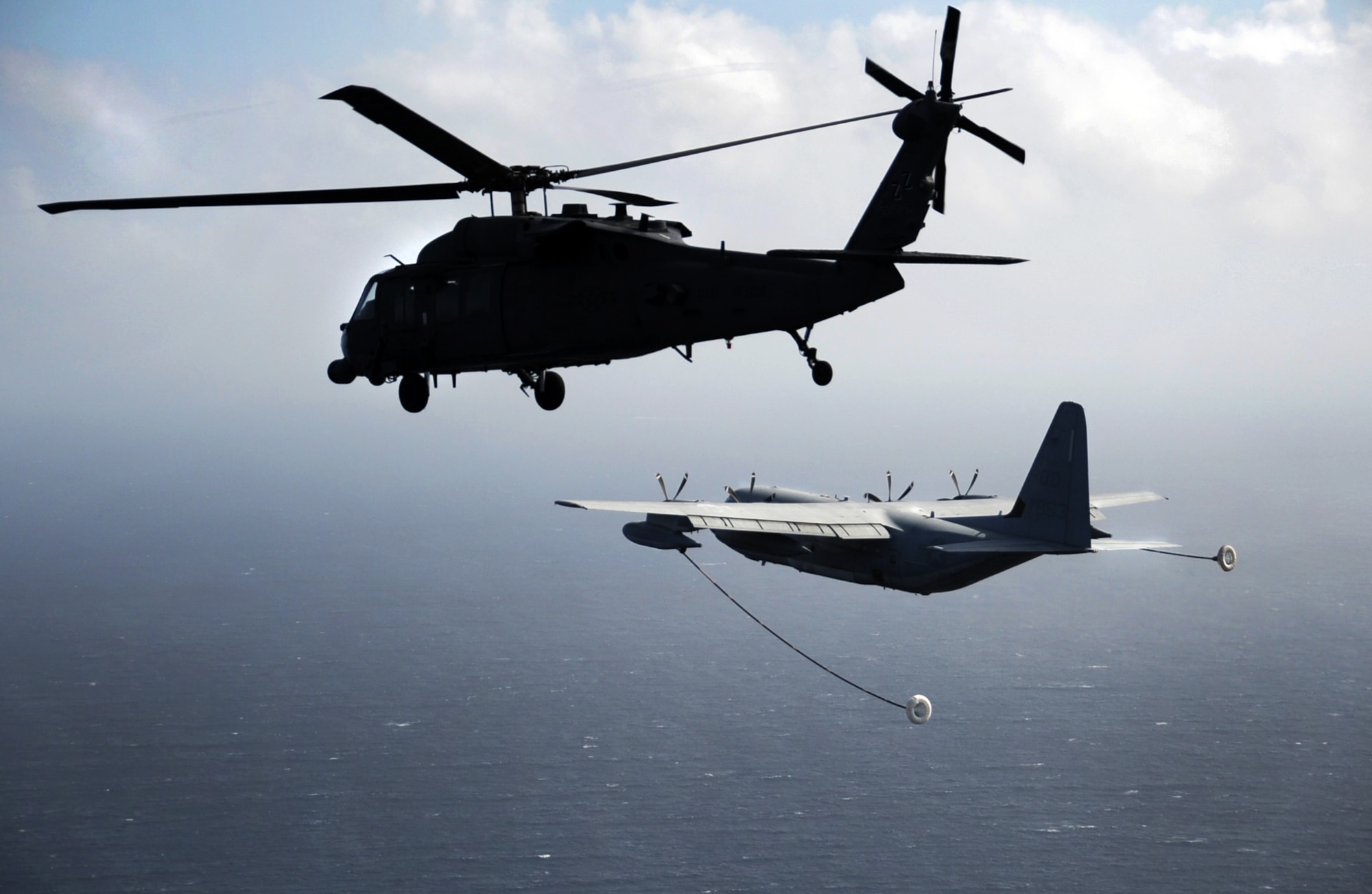 A 33rd Rescue Squadron HH-60 Pave Hawk from Kadena Air Base, Japan, prepares to be refueled en route to Osan Air Base, Republic of Korea, Oct. 10, 2012. The 31st and 33rd RQSs traveled to Osan to team up with the 25th Fighter Squadron to participate in Pacific Thunder 2012. Pacific Thunder is an annual two-week exercise at Osan AB that tests CSAR tactics to prepare for real-world emergency situations.  (U.S. Air Force photo/Staff Sgt. Sara Csurilla)