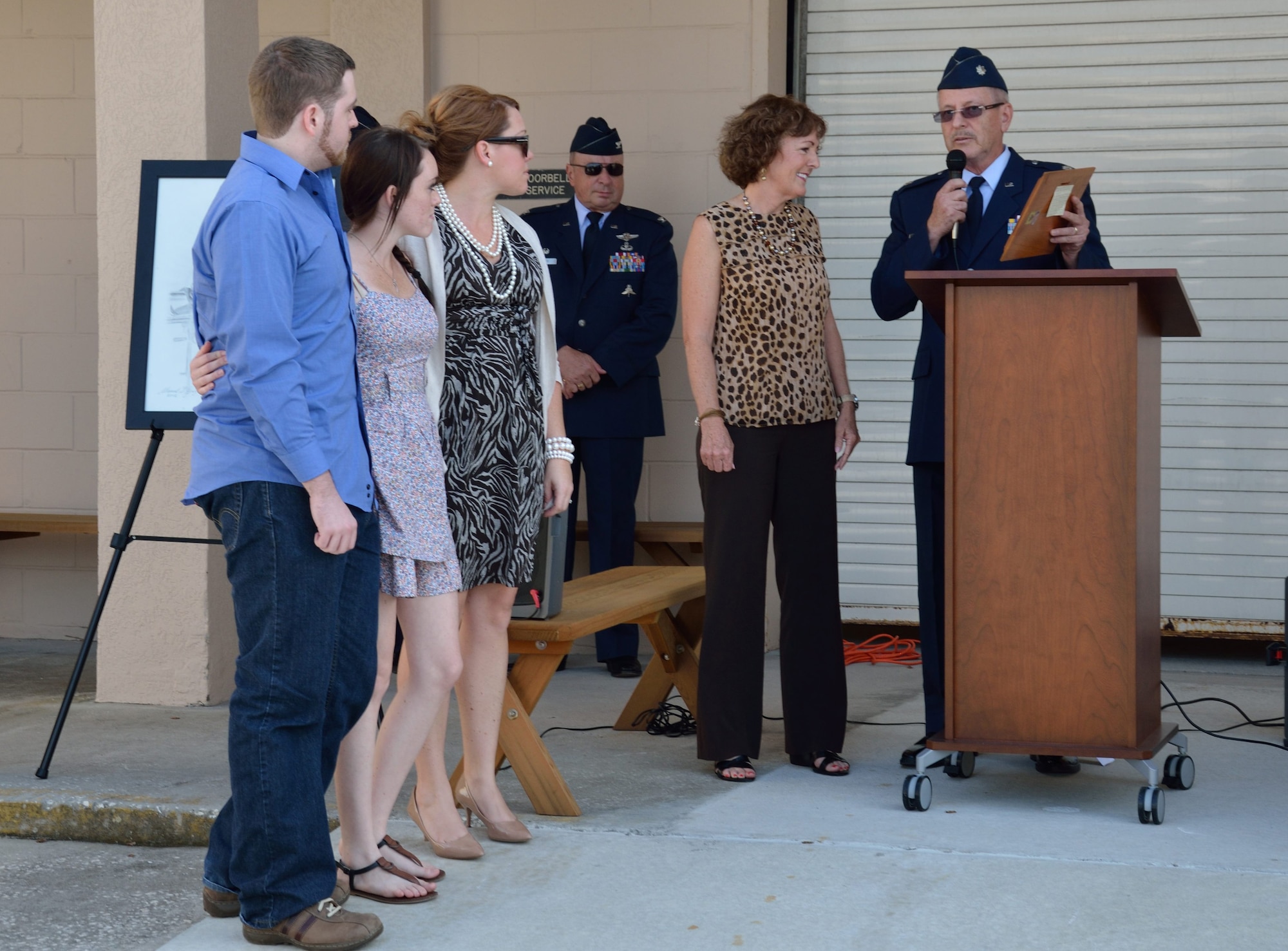 Lt. Col . Kenneth Dempsey presents Jill Wilkins and her children with a plaque from the 920th Aeromedical Staging Squadron at Patrick Air Force Base, Fla., Oct. 14, 2012. Wilkins’ husband, Maj. Kevin Wilkins, was a critical care nurse with the 920th ASTS until April 2008, when he died from a brain tumor. (U.S. Air Force photo/Staff Sgt. Anna-Marie Wyant)