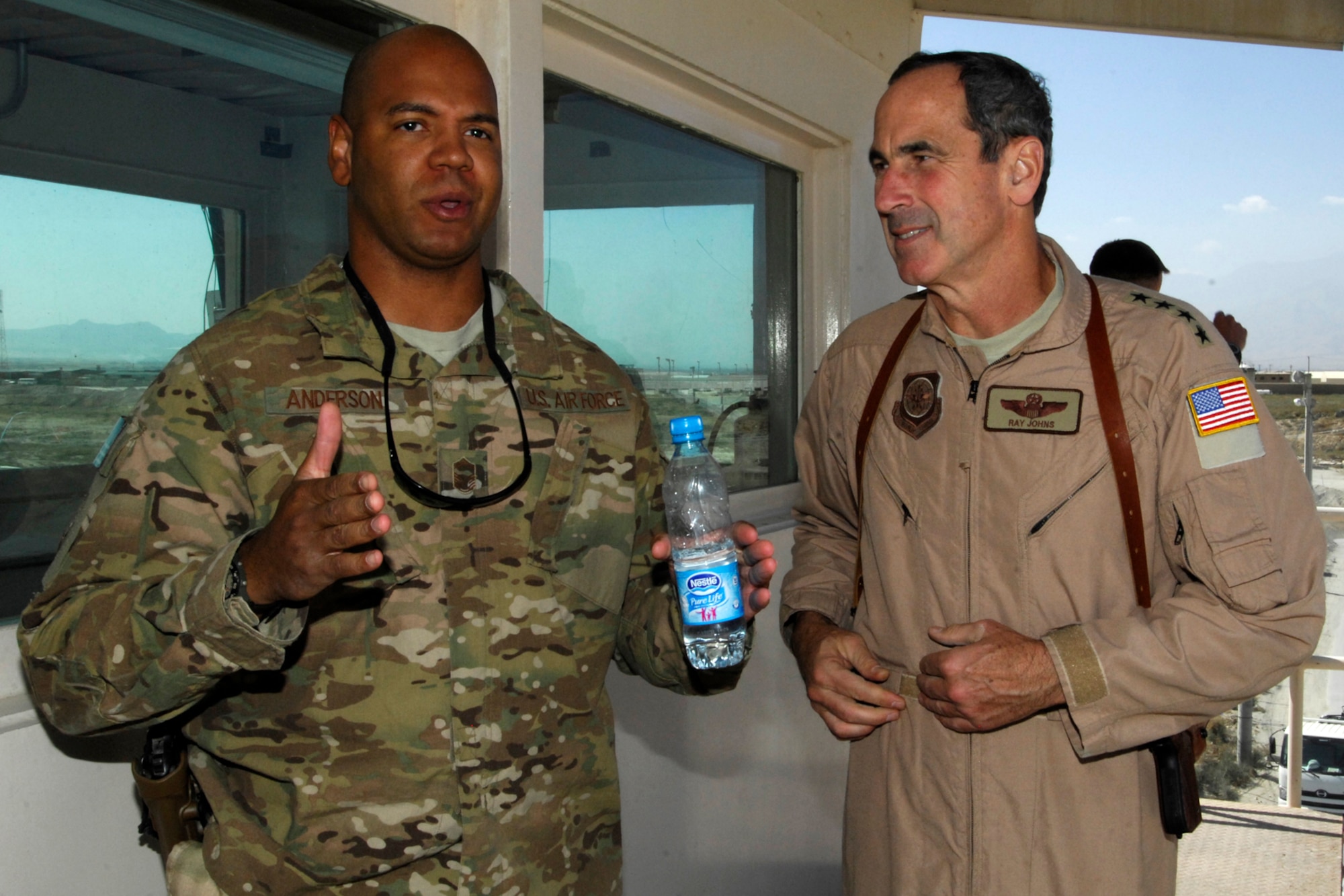 SMSgt Kenneth Anderson (left), 455th Expeditionary Aerial Port Squadron Operations superintendent, speaks with Gen. Raymond Johns, Jr., Air Mobility Command commander, during the general’s visit to Bagram Airfield, Afghanistan, Oct. 12, 2012. Anderson discussed with the general the capabilities of the Aerial Porters in moving thousands of tactical vehicles, pallets and passengers. (U.S. Air Force photo/SSgt Jeff Nevison)