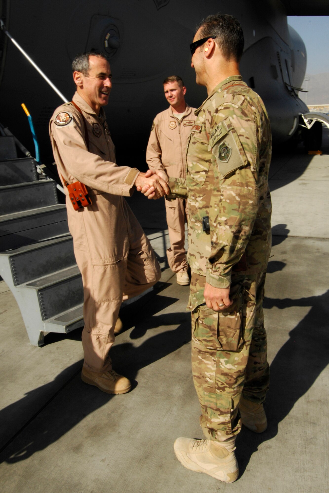 Gen. Raymond Johns, Jr., Air Mobility Command commander (left), is greeted by Brig. Gen. Joseph Guastella, 455th Air Expeditionary Wing commander, as Johns arrives at Bagram Airfield, Afghanistan, Oct. 12, 2012. The general met with several leaders to discuss future airlift operations. (U.S. Air Force photo/SSgt Jeff Nevison)
