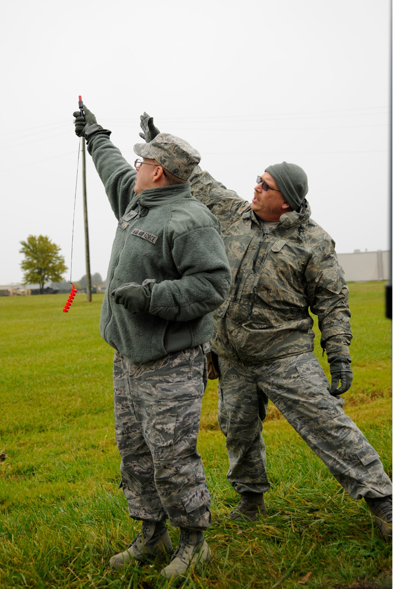 Master Sergeant James Ford of the 171st Air Refueling Squadron instructs Staff Sergeant Tom Clark from the 127th Logistics Readiness squadron on the proper way to fire a rescue flare at Selfridge Air National Guard Base, Mich., Oct. 13, 2012. Several flight crews participated in training using different survival tools such as the flare.   (U.S. Air Force photo by TSgt. David Kujawa)