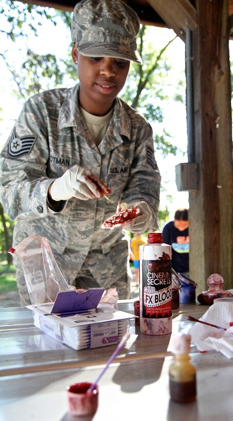 Tech. Sgt. Shauntel Cotman, a 932nd Airlift Wing Aeromedical Staging Squadron medical technician, works with special effect blood to give realism to the various simulated wounds during a mass casuality exercise at the Air Force Reserve Command wing, located at Scott Air Force Base.  (U.S. Air Force photo/ Tech. Sgt. Christopher Parr)
