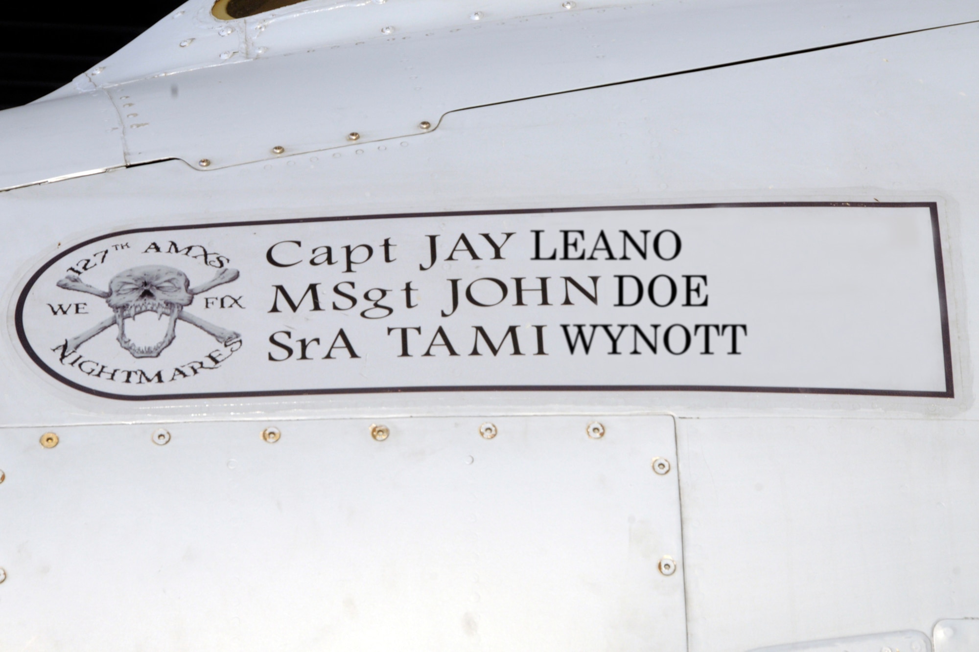 This photo illustration shows the names of a pilot and two crew chiefs, along with the logo of the 127th Aircraft Maintenance Squadron, on the skin of an A-10 Thunderbolt II, at Selfridge Air National Guard Base, Mich. The names painted on the aircraft are not necessarily the names of the individuals who will fly and work on that particular aircraft every day, but are part of the squadrons who are assigned to the aircraft. The names of the individuals in this photo have been electronically altered for security purposes. (Air National Guard photo illustration by Brittani Baisden)