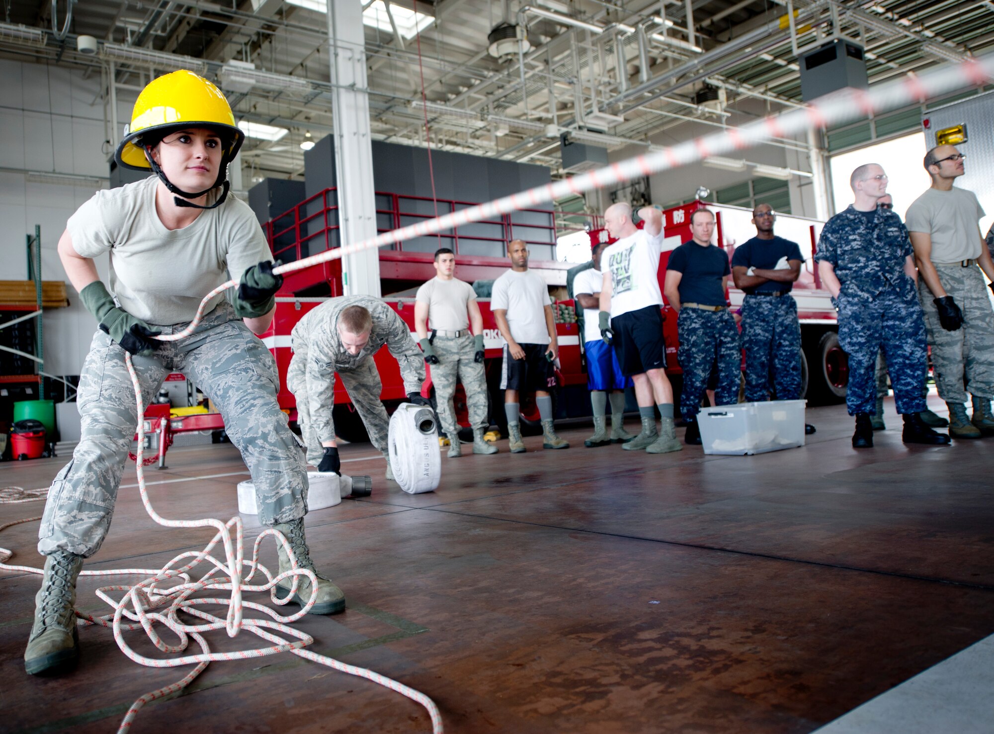 YOKOTA AIR BASE, Japan -- Senior Airman Ernia Hellen, 374th Security Forces Squadron, pulls a hose during the hose drag portion of the Fire Prevention Week Fire Muster Competition at Yokota Air Base, Japan Oct. 12, 2012. During Fire Prevention Week, the Yokota community is encouraged to participate in fire prevention activities at home, work and school. (U.S. Air Force photo by Staff Sgt. Stacy Moless)      