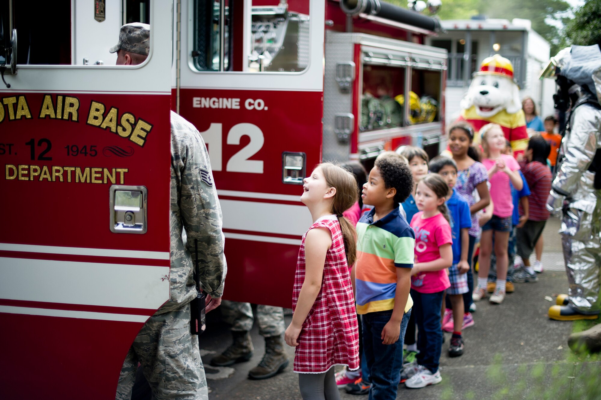 YOKOTA AIR BASE, Japan -- Children from Joan K. Mendel Elementary School wait their turn to tour a fire truck at Yokota Air Base, Japan Oct. 10, 2012. Firefighters from the base visited both elementary schools to demonstrate fire safety during Fire Prevention Week. (U.S. Air Force photo by Staff Sgt. Stacy Moless) 
