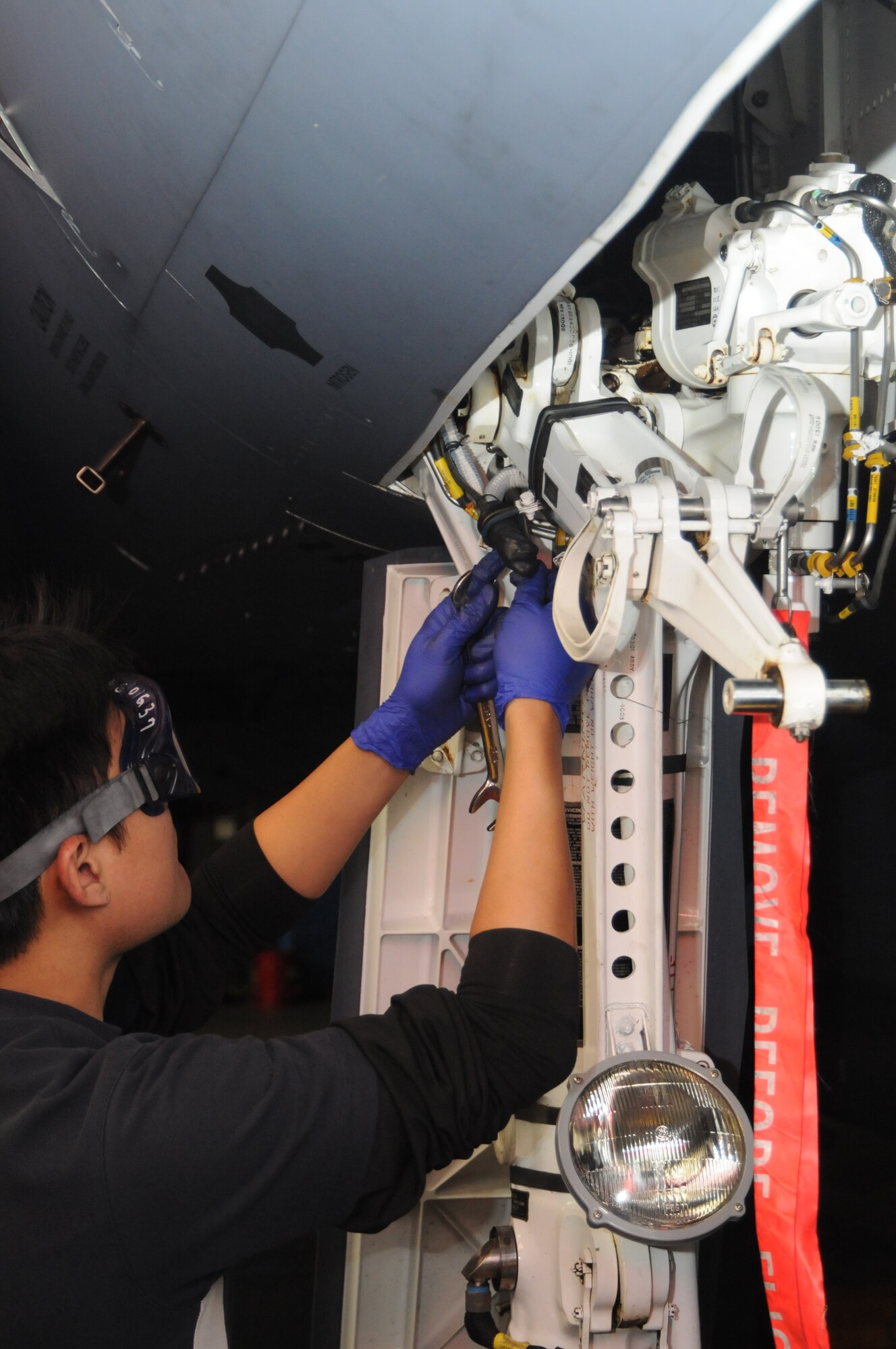 ME1 Huang Wei Lun, 428th Fighter Squadron aero systems specialist, replaces the nose landing gear shock strut assembly Oct. 12, 2012, at Eielson Air Force Base, Alaska. No chances are taken when it comes to any aircraft discrepancy as aircrew safety is the number one priority. (U.S. Air Force photo/Senior Airman Benjamin Sutton/Released)