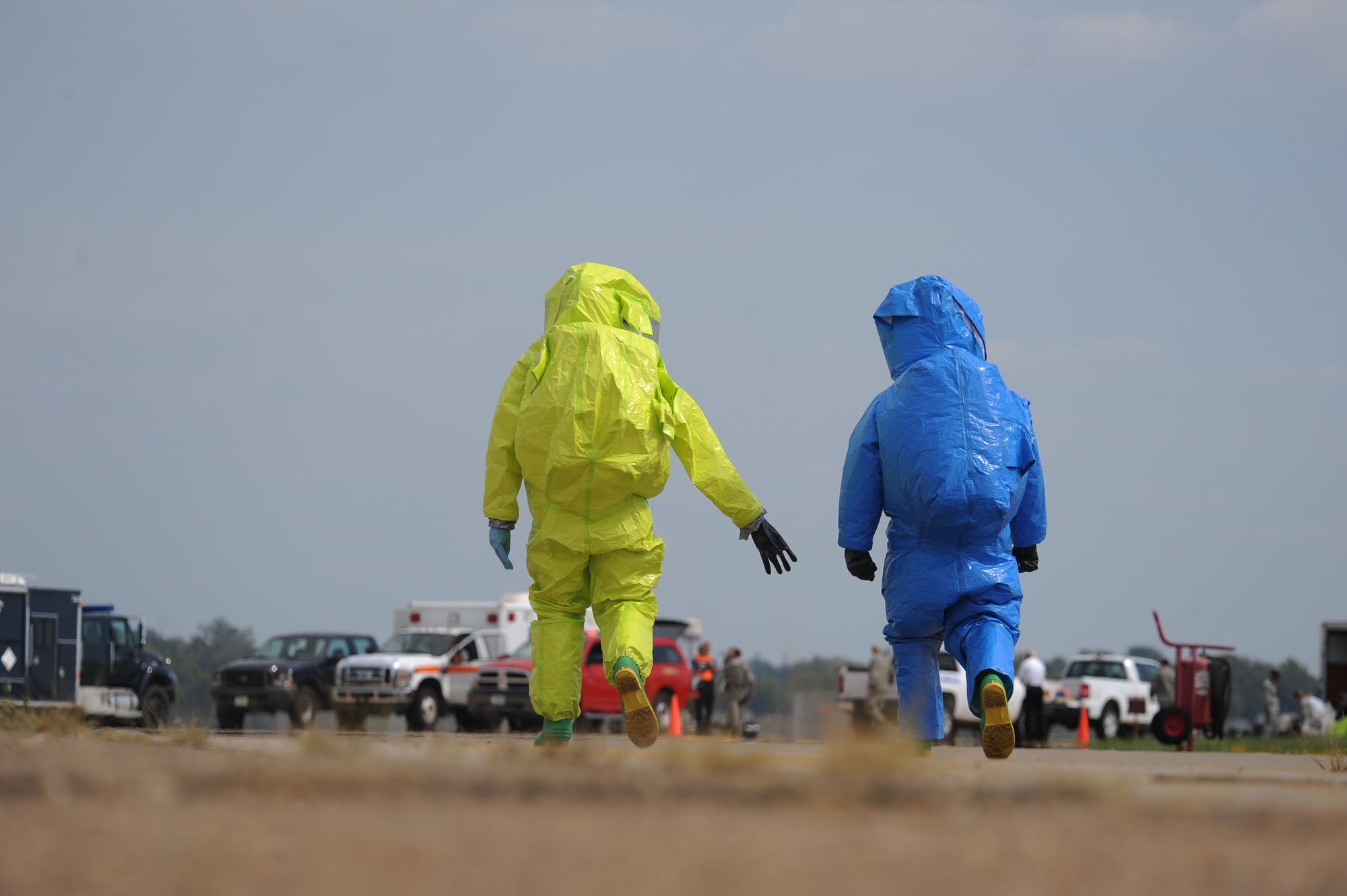 Airman 1st Class Brian Foley, left, 2nd Civil Engineer Squadron emergency management, and Staff Sgt. Shawn Gallagher, 2nd Aerospace Medicine Squadron bioenvironmental engineer technician, walk away from a simulated contaminated building during a major accident response exercise on Barksdale Air Force Base, La., Oct. 12. The Airmen donned hazardous material suits to search and test the building for simulated contaminates. After the search, the two Airmen had their vital signs taken again to see if they had any heat-stress related injuries. (U.S. Air Force photo/ Senior Airman Micaiah Anthony)(RELEASED)
