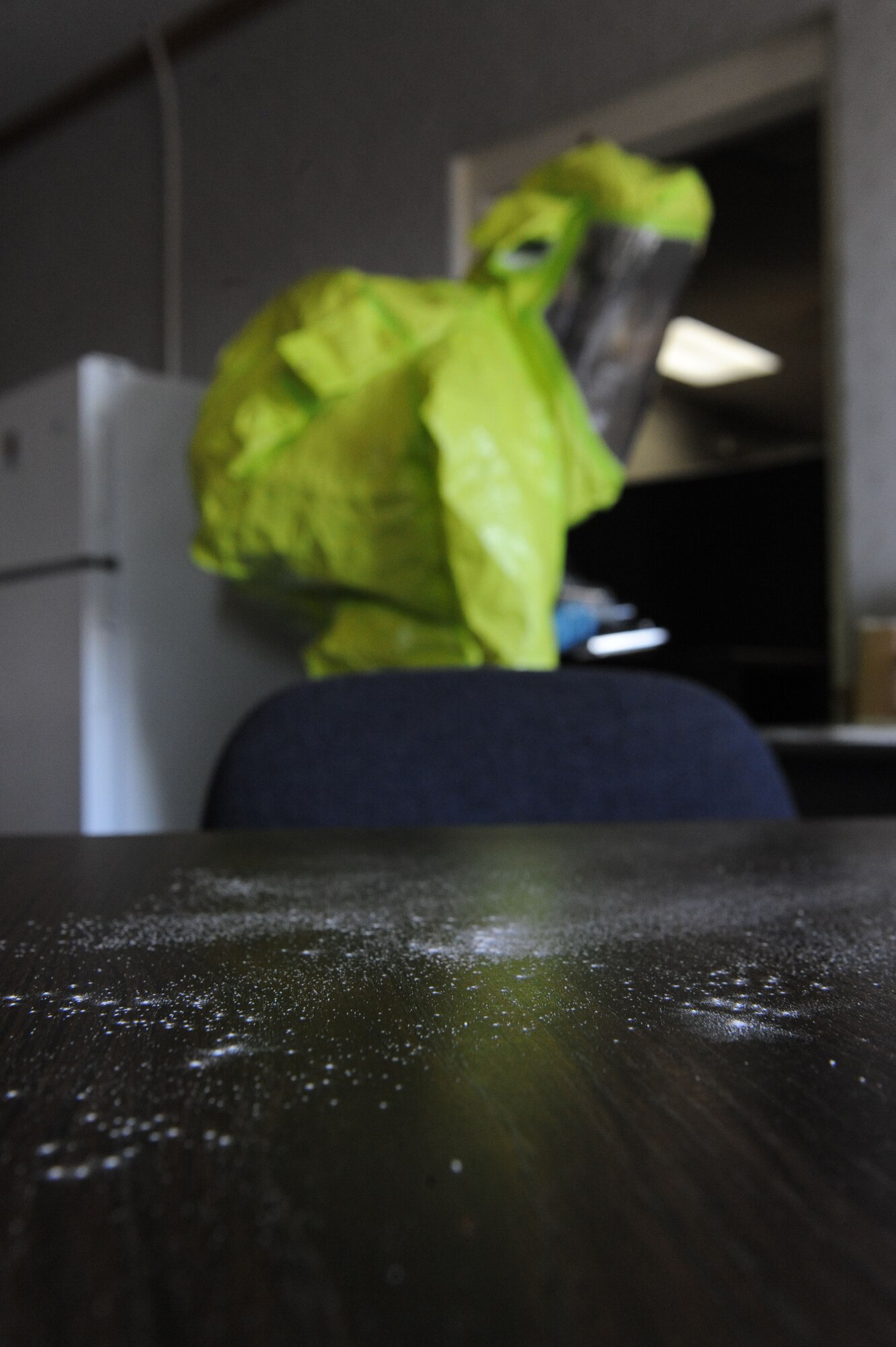 Airman 1st Class Brian Foley, 2nd Civil Engineer Squadron emergency management, walks into the Warrior Center's kitchen after examining a powdery substance during a major accident response exercise on Barksdale Air Force Base, La., Oct. 12. The MARE evaluated the response of emergency personnel to Airmen exposed to a simulated hazardous substance. Firefighters, security forces, emergency management, bioenvironmental and medical Airmen and civilians worked together to reduce the spread of the hazardous substance. (U.S. Air Force photo/ Senior Airman Micaiah Anthony)(RELEASED) 
