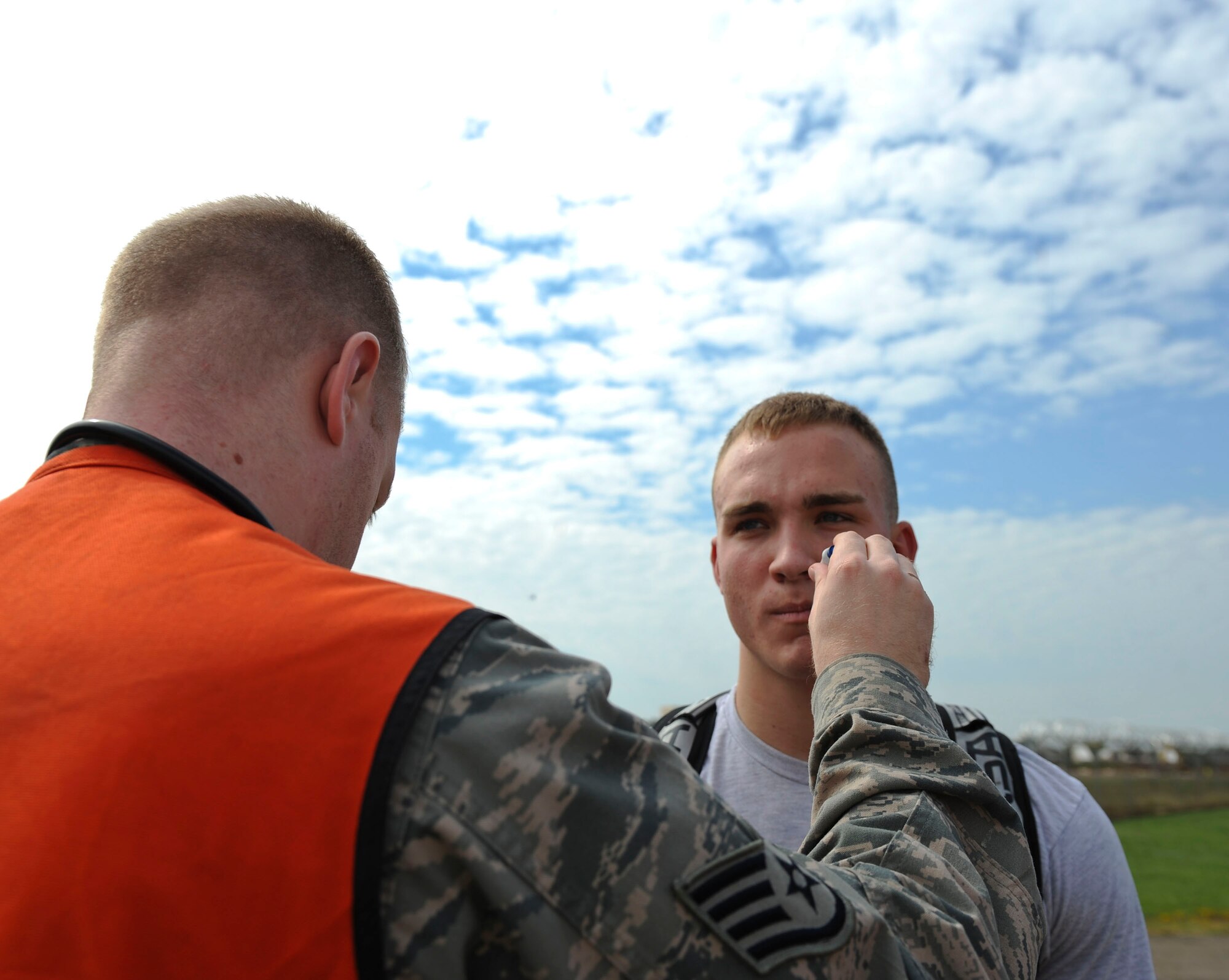 Airman 1st Class Brian Foley, 2nd Civil Engineer Squadron emergency management, gets his temperature taken by an Airman from the 2nd Medical Group during a major accident response exercise on Barksdale Air Force Base, La., Oct. 12. Foley had his temperature and vital signs taken before he donned a hazardous material suit to ensure there were no drastic changes when he returned from the contaminated area. (U.S. Air Force photo/ Senior Airman Micaiah Anthony)(RELEASED)