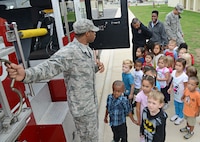 Airman 1st Class Marcell Ridley, 902nd Fire Emergency Services firefighter, teaches pre-school students at the child development center about a fire truck Oct. 9 at Joint Base San Antonio-Randolph. According to the National Archives and Records Administration's Library Information Center, Fire Prevention Week is the longest running public health and safety observance on record. The President of the United States has signed a proclamation proclaiming a national observance during that week every year since 1925. (U.S. Air Force photo by Benjamin Faske)