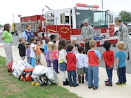 Airman 1st Class Marcell Ridley and Staff Sgt. Conrado Jaquez, 902nd Fire Emergency Services firefighters, give fire safety tips to pre-school students at the child development center Oct. 9 at Joint Base San Antonio-Randolph. According to the National Archives and Records Administration's Library Information Center, Fire Prevention Week is the longest running public health and safety observance on record. The President of the United States has signed a proclamation proclaiming a national observance during that week every year since 1925. (U.S. Air Force photo by Benjamin Faske)
