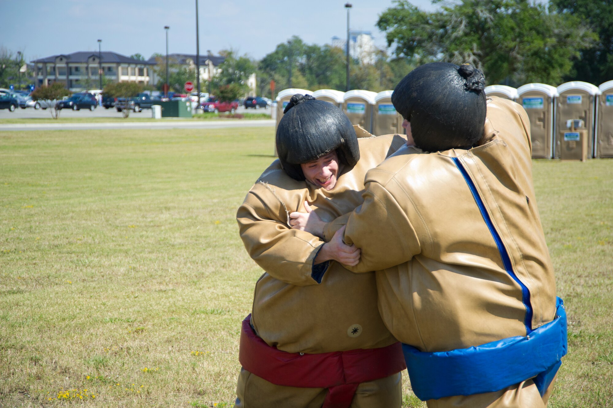 Airman 1st Class Shawn Kieffer, 81st Medical Support Squaadron, takes on Airman Steven Flick, 81st MDSS, in a sumo wrestling challenge at the dorm block party Oct. 12, 2012, at the field between the Exchange and Shaw House, Keesler Air Force Base, Miss.  (U.S. Air Force photo by Adam Bond)  (U.S. Air Force photo by Adam Bond)  (U.S. Air Force photo by Adam Bond)