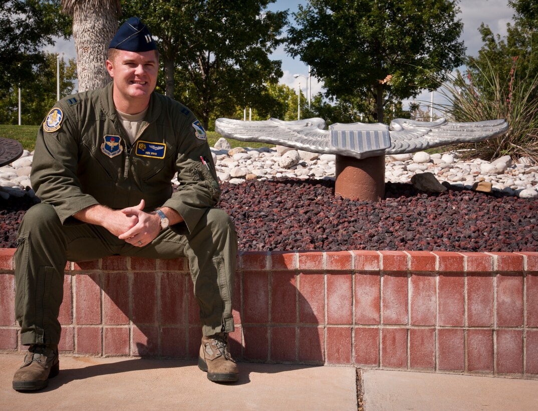 Capt. Ben Sims, 85th Flying Training Wing instructor pilot, poses next to a set of pilot wings at Heritage Park here at Laughlin Air Force Base, Texas, Oct. 10, 2012. Sims was awarded Laughlin’s XLer of the week award by Col. Tom Murphy, 47th Flying Training Wing commander, for his actions in saving a life after witnessing a vehicle crash while returning home from leave. (U.S. Air Force photo/Airman 1st Class Nathan Maysonet)