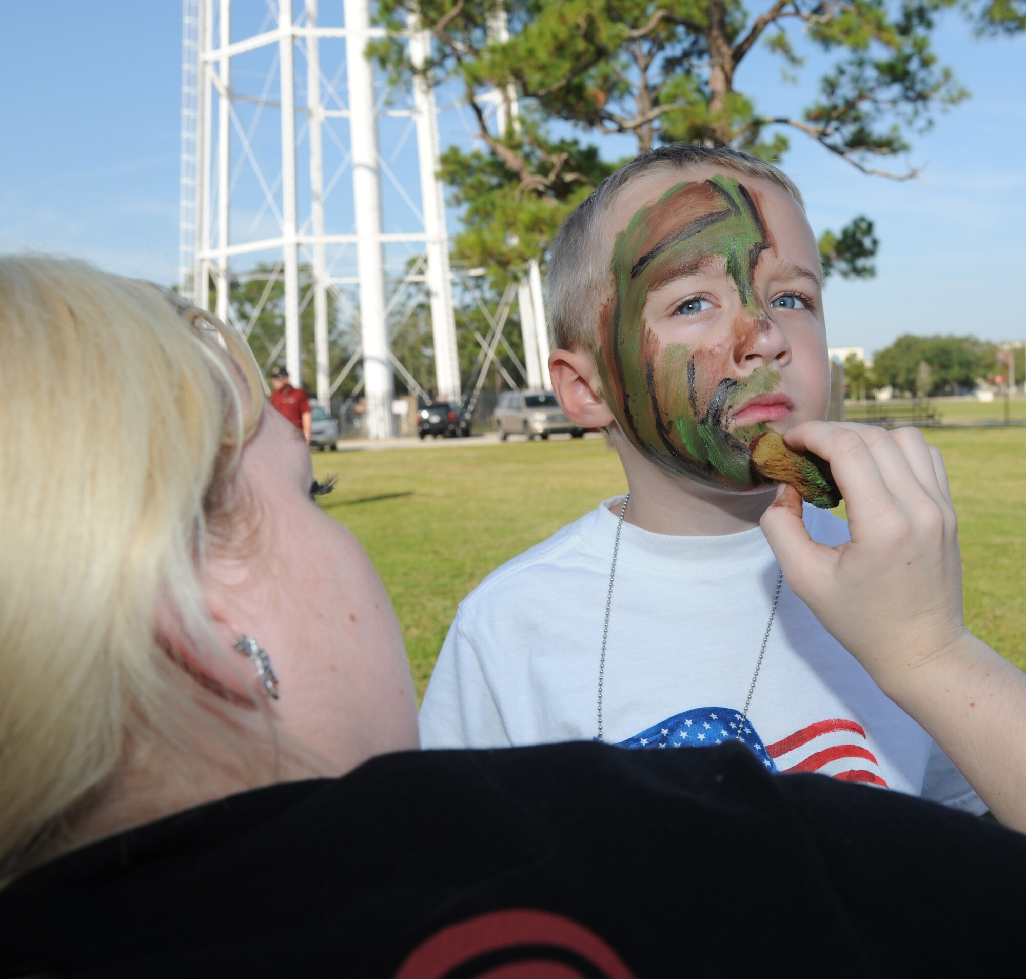 Airman 1st Class Loren Hannah, 81st Medical Support Squadron, puts camouflage paint on the face of Riley Fugate, 5, during Operation Hero Oct. 13, 2012, at Keesler Air Force Base, Miss.  Operation Hero is presented twice a year to give parents a chance to expose their children to what happens when they leave home for deployments tasking or on temporary duty.  Riley’s parents are Paula and 1st Lt. John Fugate, 345th Airlift Squadron.  Fugate is currently deployed to Afghanistan.  (U.S. Air Force photo by Kemberly Groue)