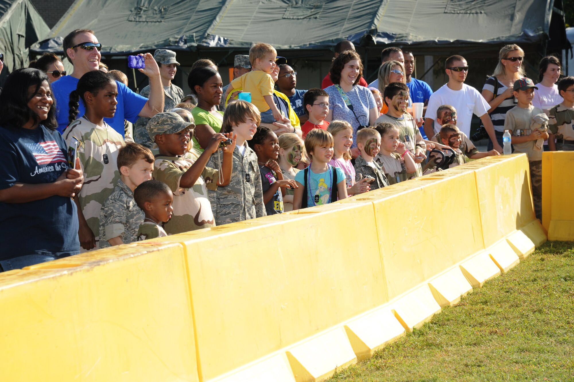 Participants of Operation Hero watch a military working dog demonstration during the event Oct. 13, 2012, at Keesler Air Force Base, Miss.  Operation Hero is presented twice a year to give parents a chance to expose their children to what happens when they leave home for deployments tasking or on temporary duty.  (U.S. Air Force photo by Kemberly Groue)