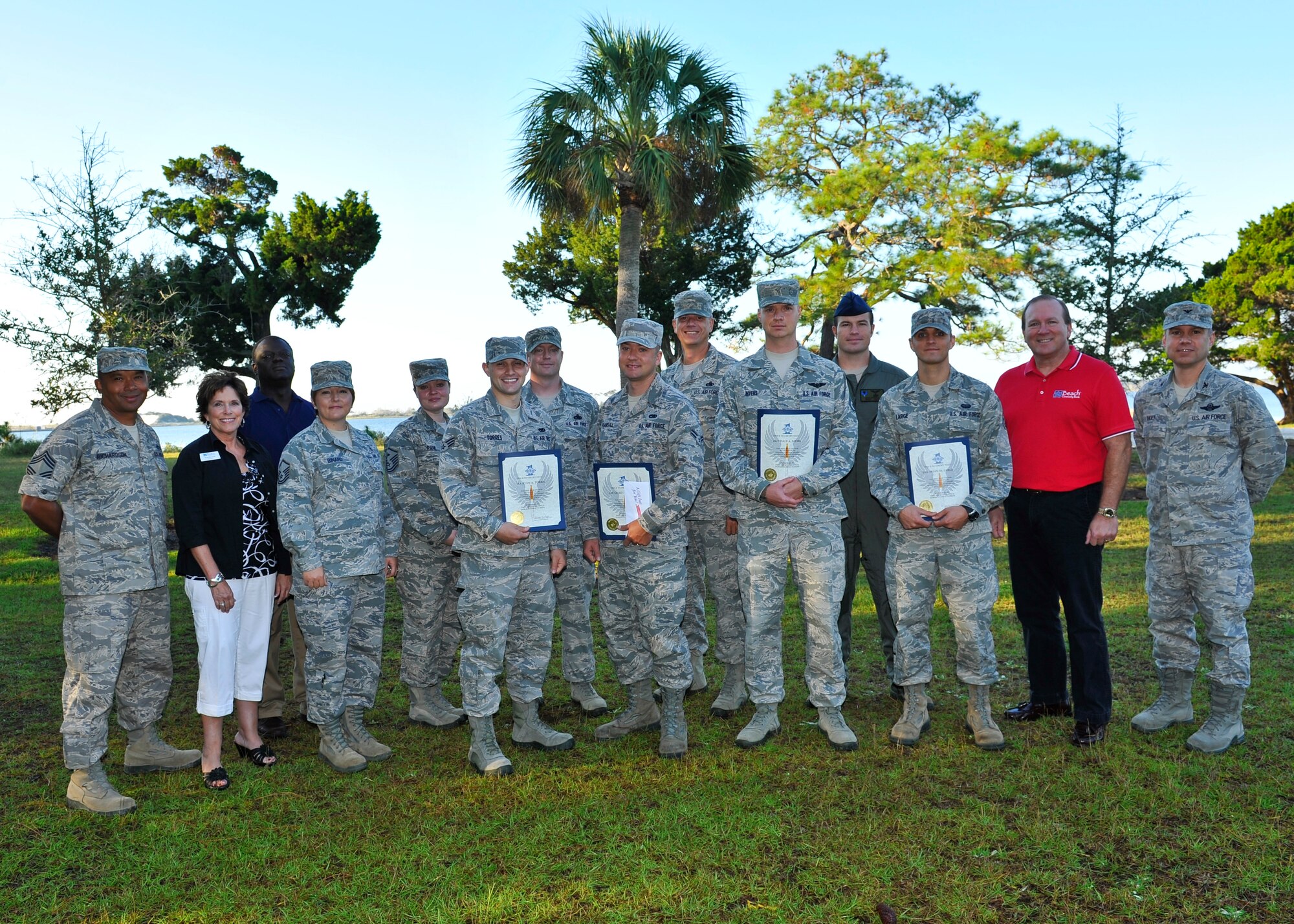 Leadership from 1st Special Operations Wing and the Emerald Coast community pose with four Airmen who received the Diamond Sharp award during a presentation at the Soundside club on Hurlburt Field, Fla., Oct 12, 2012. This month's recipients were (from left) Senior Airman Ryan Torres, 1st Special Operations Component Maintenance Squadron, Airman 1st Class Chad Pearsall, 801st Special Operations Maintenance Squadron, Staff Sgt. Dale Myers, 25th intelligence Squadron, Senior Airman Brian Large, 1st Special Operations Communication Squadron. (U.S. Air Force photo/Staff Sgt. John Bainter) 
