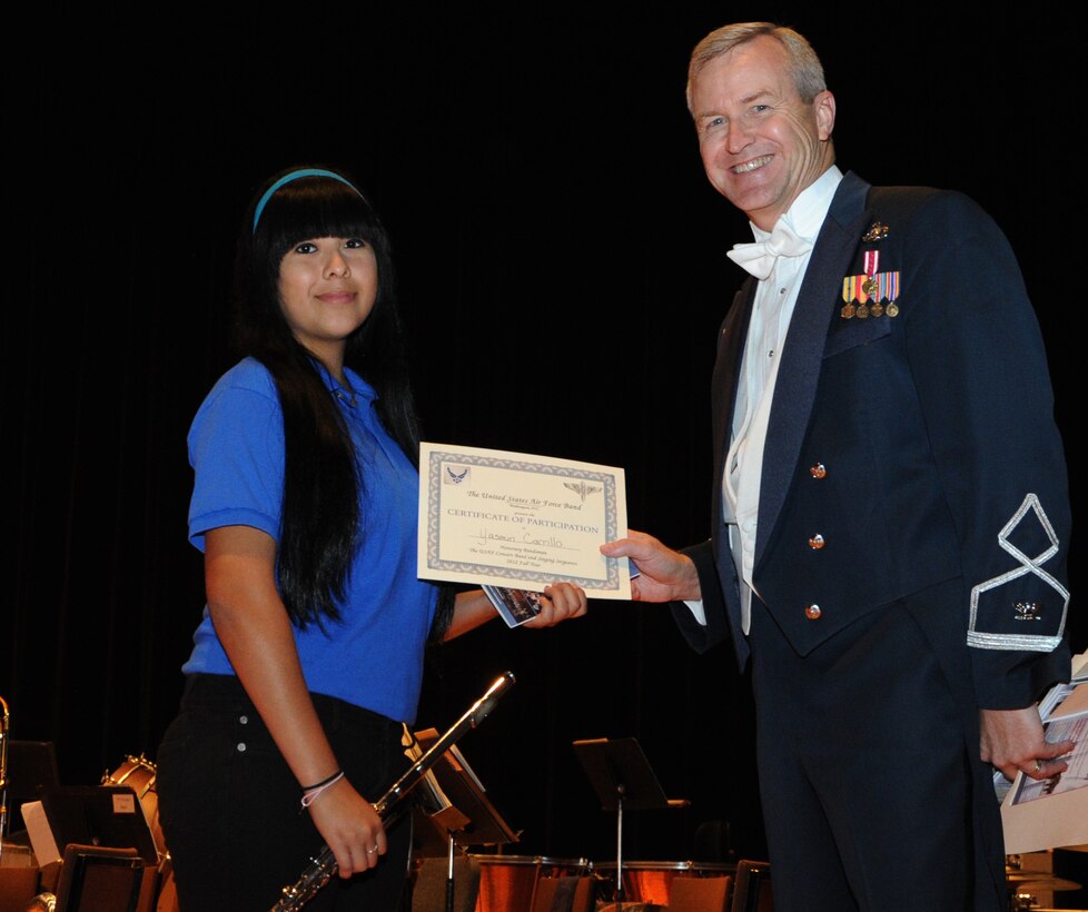 Col. Larry Lang, U.S. Air Force Band, commander and conductor presents a certificate to an Honorary Bandsmen during the  U.S. Air Force Band and Singing Sergeants 2012 Fall Tour at The National Steinbeck Center's Sherwood Hall in Salinas, Calif., Oct 14. The concert at the National Steinbeck Center is the third of 14 performances that will take place during the fall tour of California and Arizona. (U.S. Air Force photo/ Staff Sgt. Keyonna Fennell)