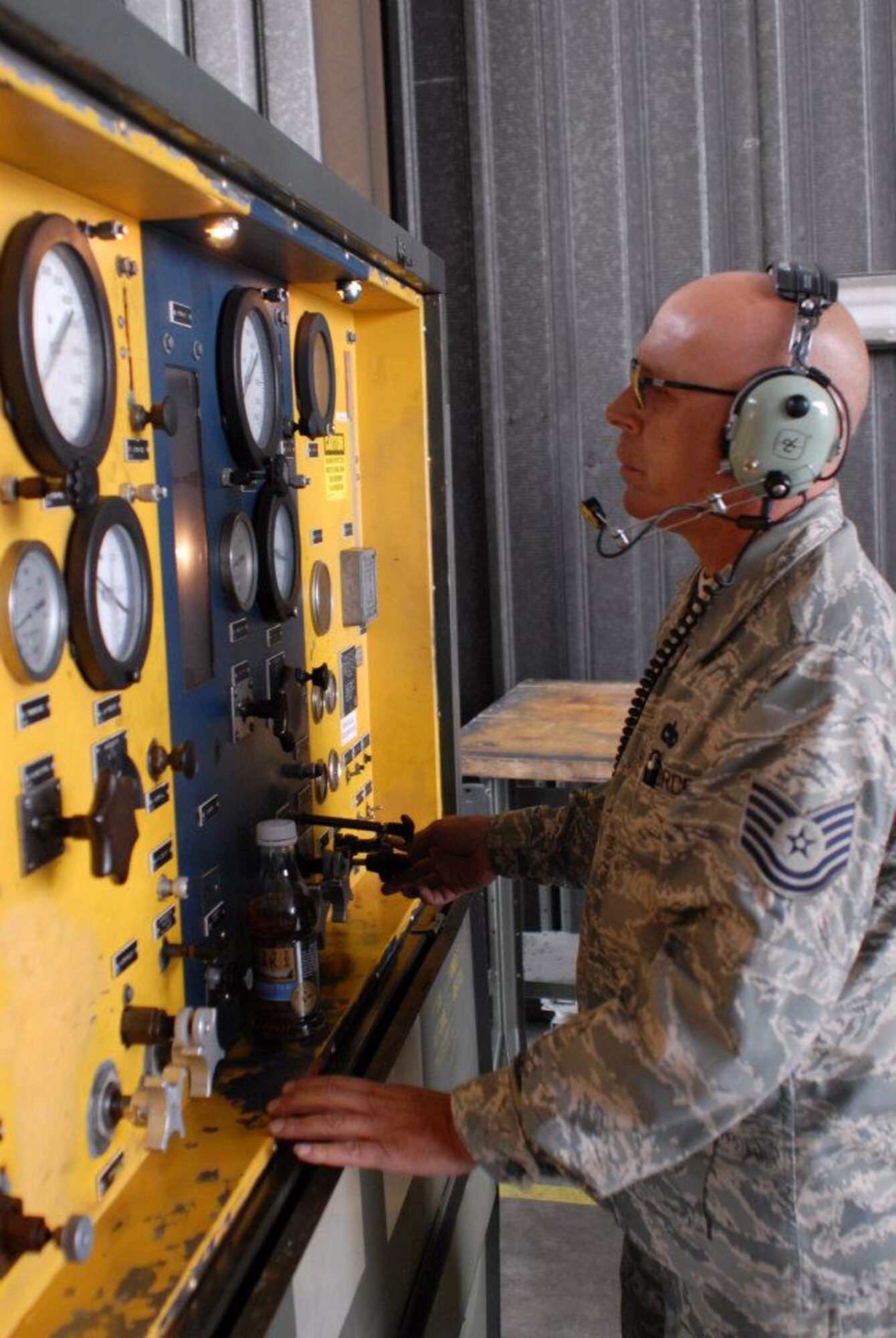 Tech Sgt. Edmund Poitinger a pneudraulics mechanic from the 180th Fighter Wing in Toledo, Ohio, operates a hydraulic test stand while troubleshooting a landing gear problem for an F16 in Great Falls, Montana, August 3, 2012. Members of the 180FW travelled to Great Falls, Montana to participate in exercise “Hang em’ High” to practice dissimilar air combat training. (U.S. Air Force photo by Staff Sgt. Stephen Reddick/Released)