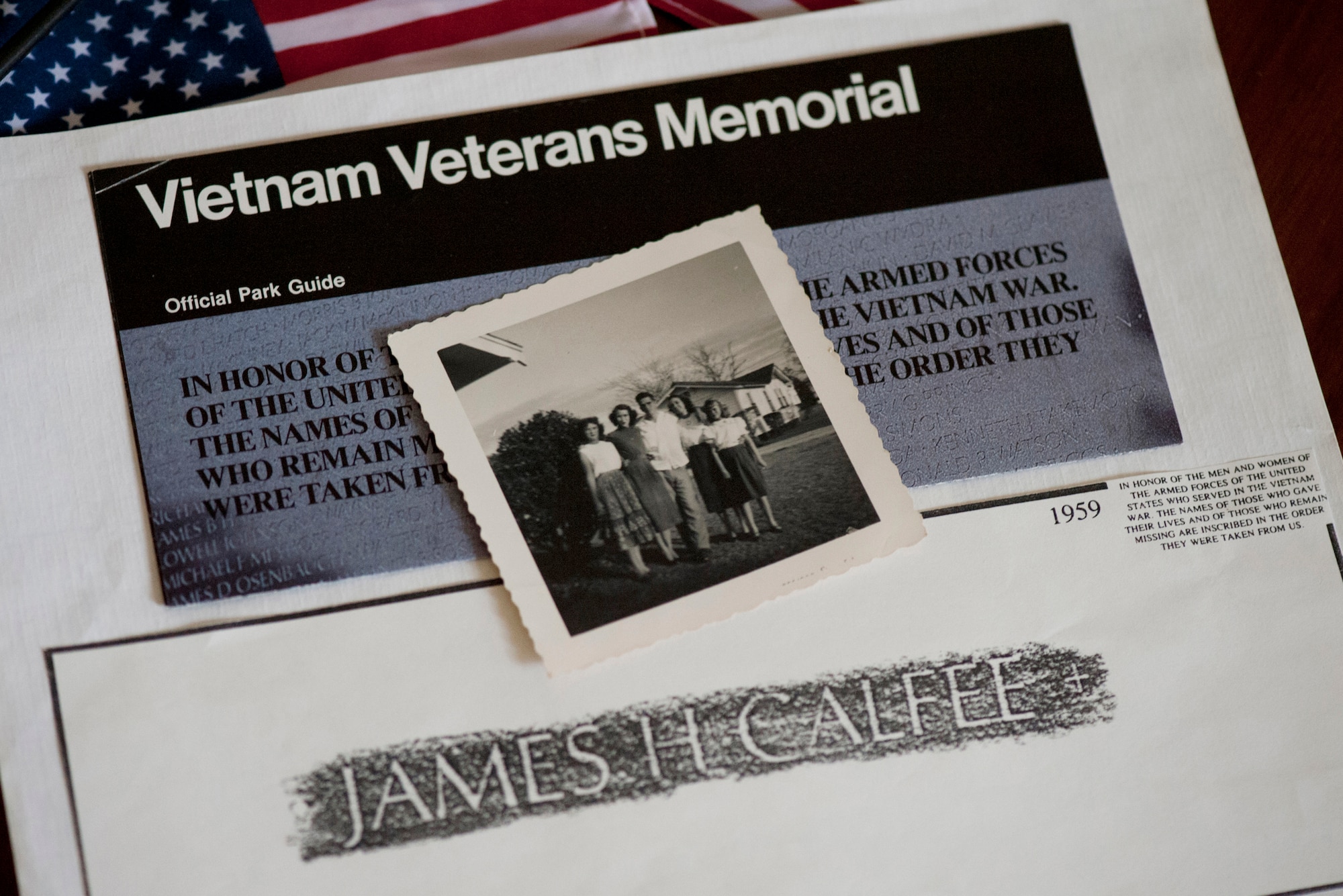 A photo of the late Master Sgt. James Calfee with his sisters sits on a Vietnam Veterans Memorial guide in Houston, Texas, Aug. 22, 2012. (U.S. Air Force photo/Val Gempis)