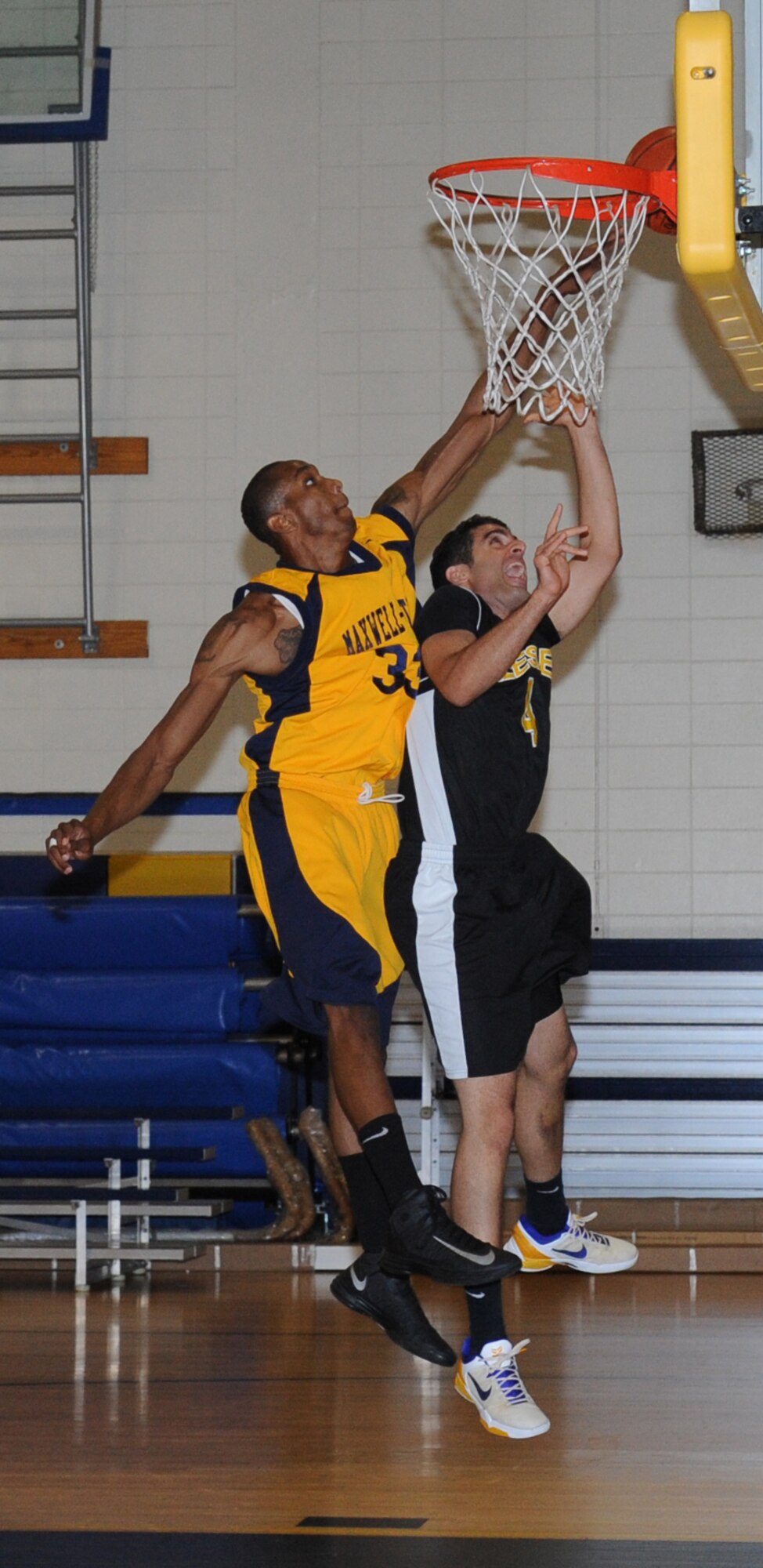 Brandon Carter, Maxwell-Gunter, leaps in the air for a successful block against Jimmy Pajuheshfar, Keesler, during the men’s varsity basketball game Oct. 13, 2012, at the Blake Fitness Center, Keesler Air Force Base.  Maxwell-Gunter defeated Keesler, 74-68.  The Keesler women’s varsity team played an exhibition game against the Mississippi Lady Storms.  Keesler defeated the Lady Storms 55-37.  (U.S. Air Force photo by Kemberly Groue)