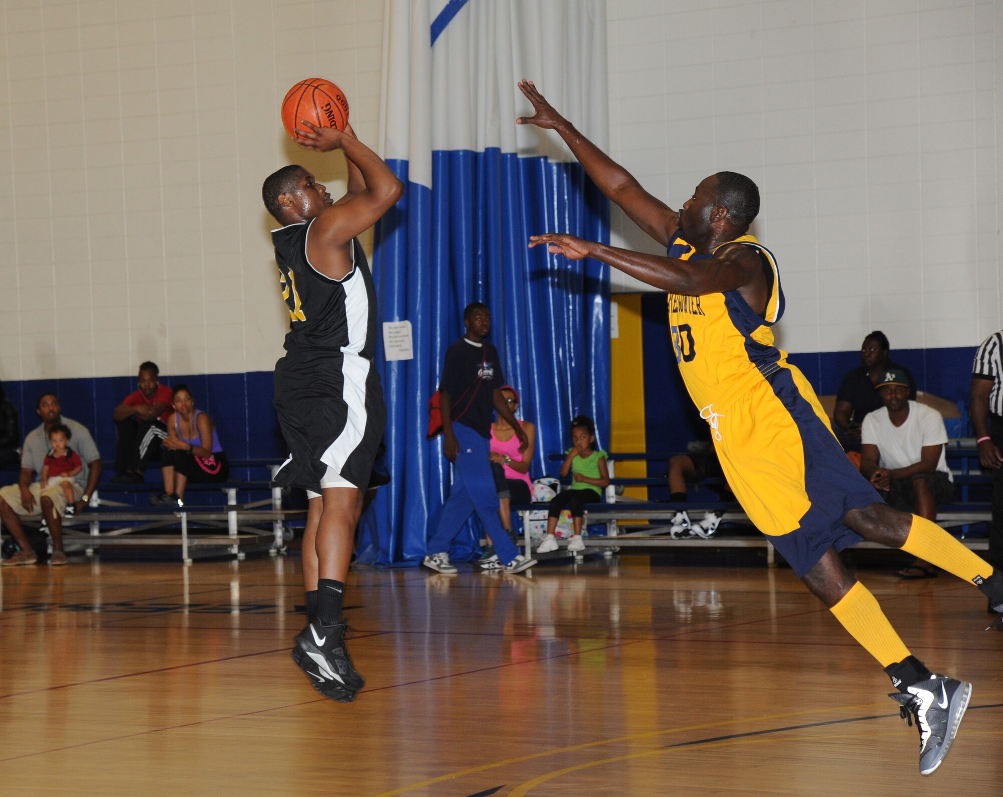 David Thatch, Keesler, attempts a three-point jump shot as Alexander Nelson, Maxwell-Gunter, attempts a block during the men’s varsity basketball game Oct. 13, 2012, at the Blake Fitness Center, Keesler Air Force Base.  Maxwell-Gunter defeated Keesler, 74-68.  The Keesler women’s varsity team played an exhibition game against the Mississippi Lady Storms.  Keesler defeated the Lady Storms 55-37.  (U.S. Air Force photo by Kemberly Groue)