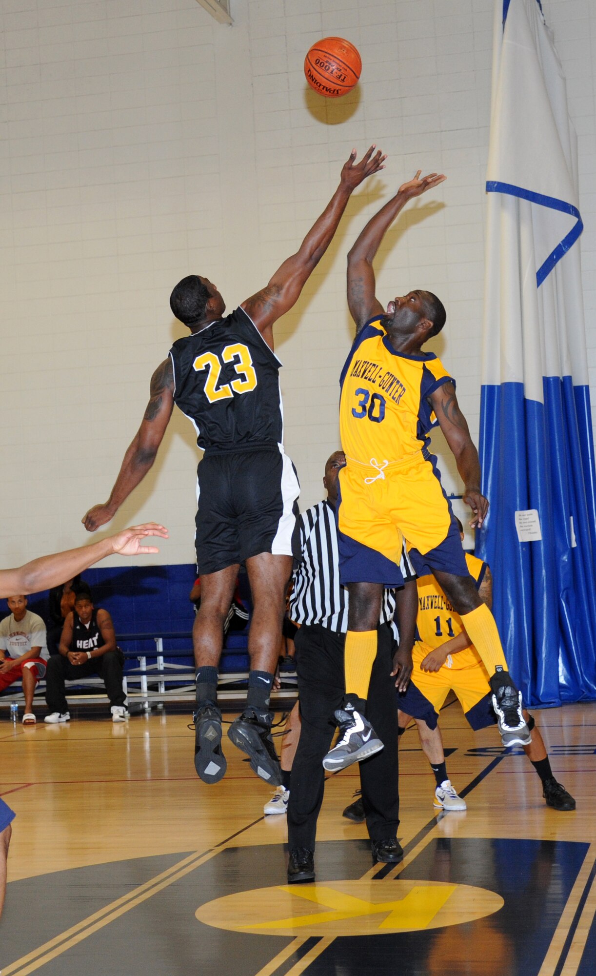 Calvin Walker, Keesler, and Alexander Nelson, Maxwel-Gunter, perform the tip-off to start the men’s varsity basketball game Oct. 13, 2012, at the Blake Fitness Center, Keesler Air Force Base.  Maxwell-Gunter defeated Keesler, 74-68.  The Keesler women’s varsity team played an exhibition game against the Mississippi Lady Storms.  Keesler defeated the Lady Storms 55-37.  (U.S. Air Force photo by Kemberly Groue)