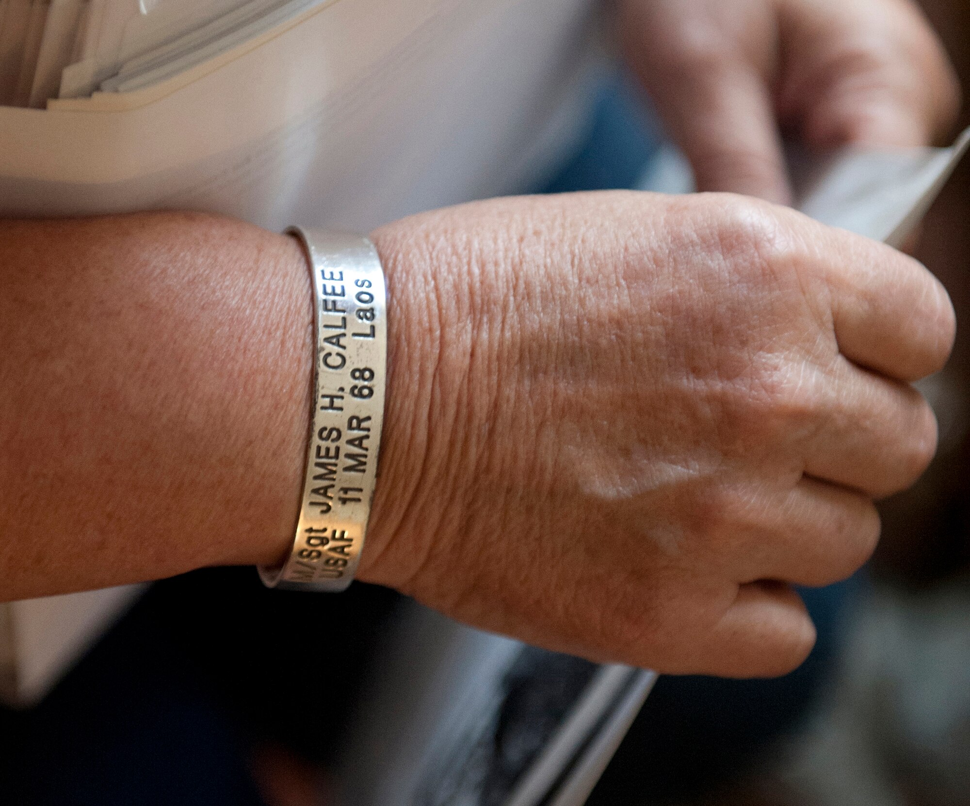 Debra Morris, a niece of U.S. Air Force Master Sgt. James Calfee, wears a Vietnam War POW/MIA bracelet in honor of her late uncle in Houston, Texas, Aug. 22, 2012. Calfee was killed in action in Laos in 1968. (U.S. Air Force photo/Val Gempis)
