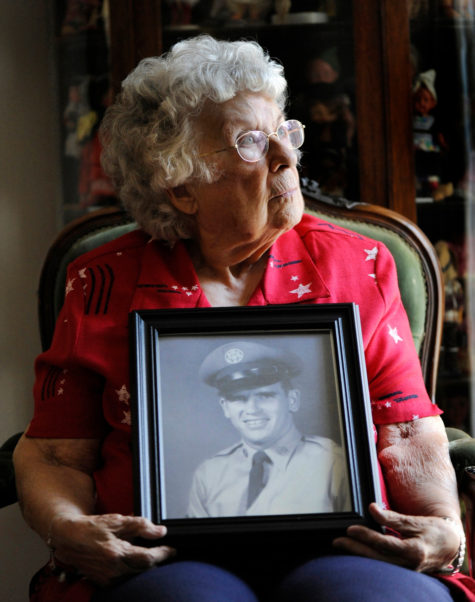 Rosalie Bacicia, sister of the late Master Sgt. James Calfee, reflects as she holds a photo of her brother in Houston, Texas, Aug. 22, 2012. Calfee, who was posthumously awarded the Silver Star Medal, was killed in action in Laos in 1968. (U.S. Air Force photo/Val Gempis)
