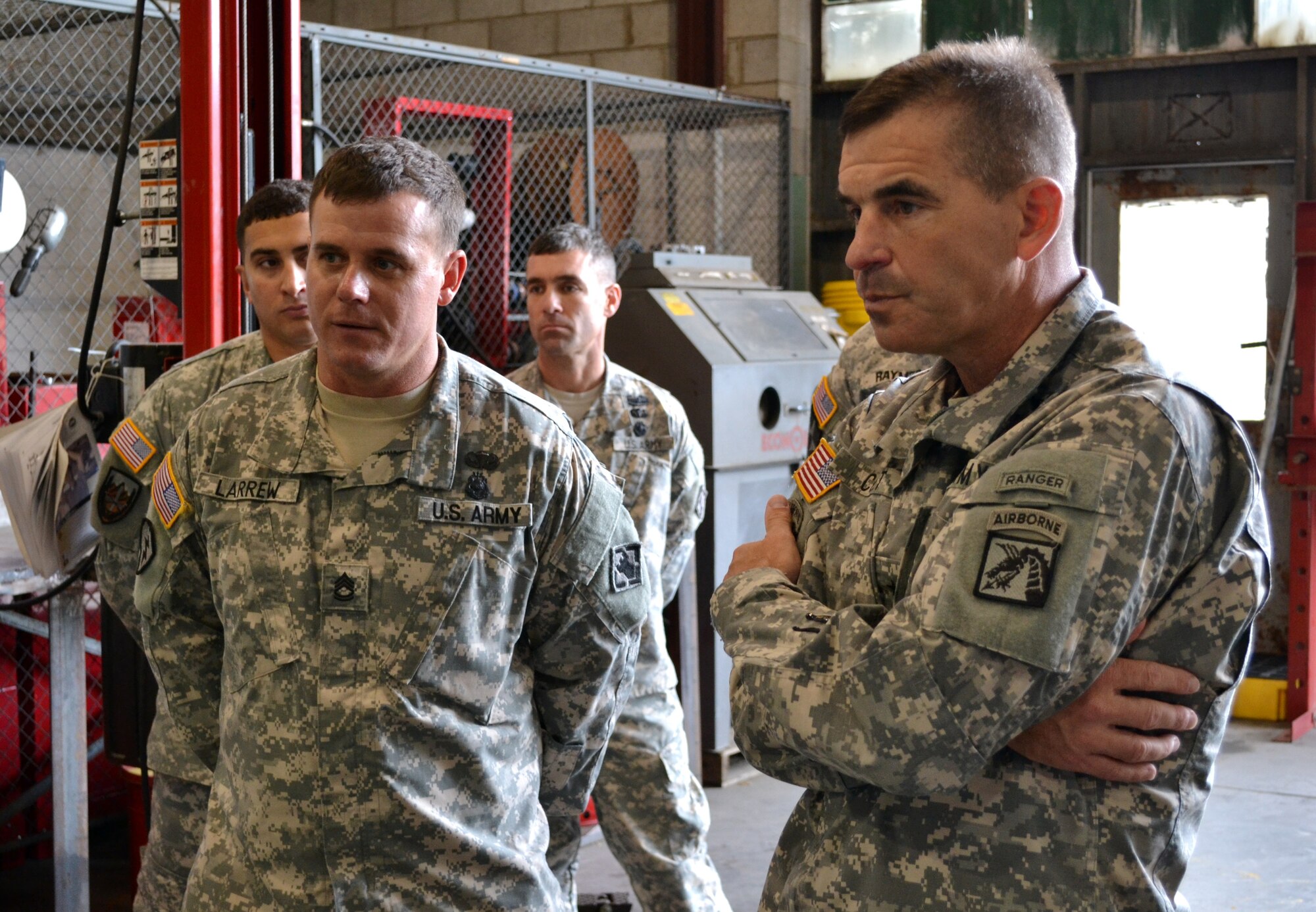 U.S. Army Brig. Gen. Jeffrey N. Colt, 18th Airborne Corps deputy commanding general, listens to Sgt. 1st Class Jonathan Larrew, first sergeant of the detachment, during a visit to the 7th Sustainment Brigade Oct 3. Colt also toured the Atlas forklift, Kalmar, and watercraft simulation centers on base, and met with watercraft Soldiers while visiting 3rd Port. (U.S. Army photo by Sgt. Edwin Junior Rodriguez / Released)