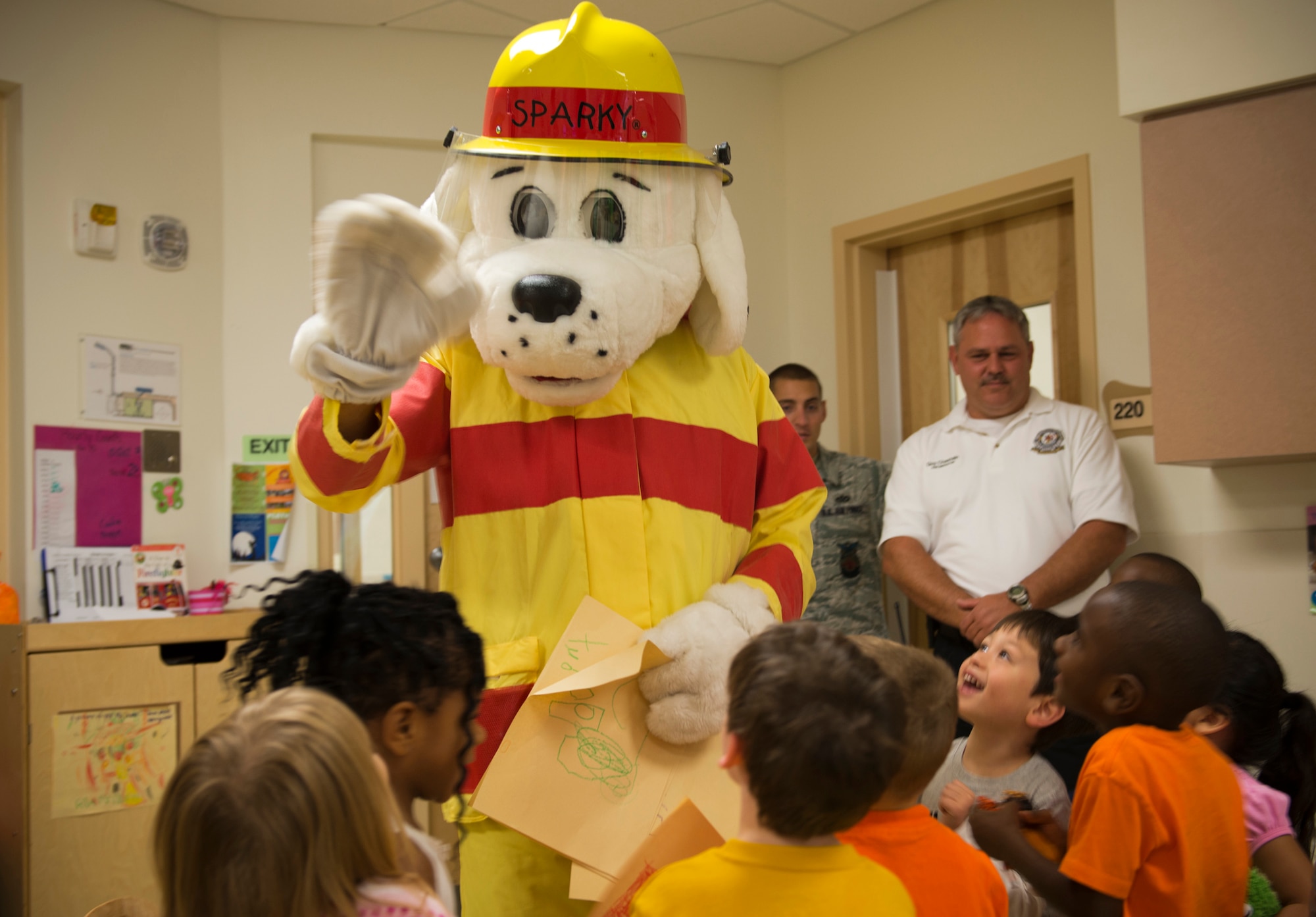 Children from the Child Development Center give drawings to Sparky the Fire Dog at Moody Air Force Base Ga., Oct. 10, 2012. Sparky danced and sang for the kids as part of National Fire Prevention Week. (U.S. Air Force photo by Senior Airman Douglas Ellis/Released)

