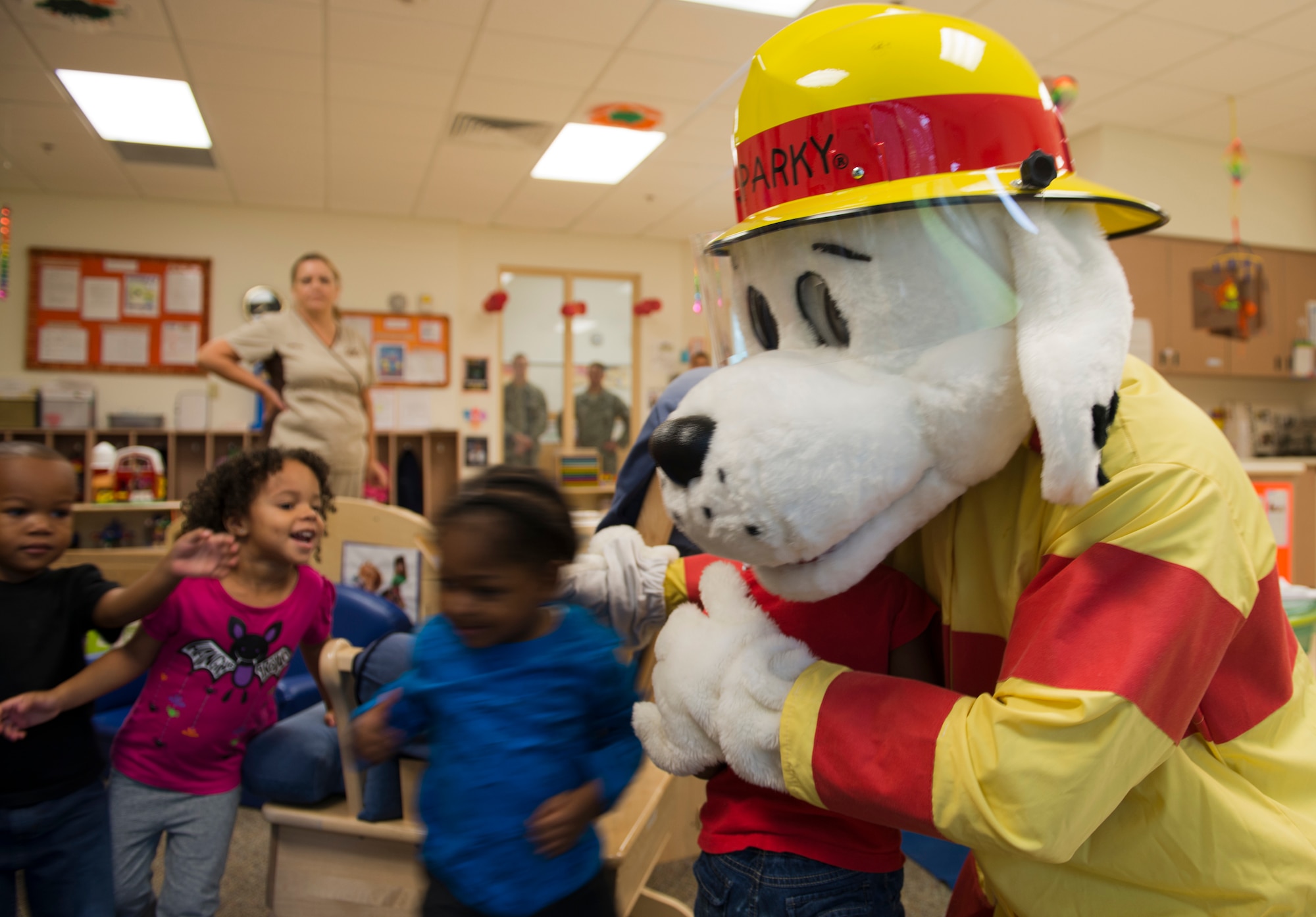 Sparky the Fire Dog hugs children at the Child Development Center at Moody Air Force Base Ga., Oct. 10, 2012. Sparky also visited children at local elementary schools to help educate them on fire prevention. (U.S. Air Force photo by Senior Airman Douglas Ellis/Released)

