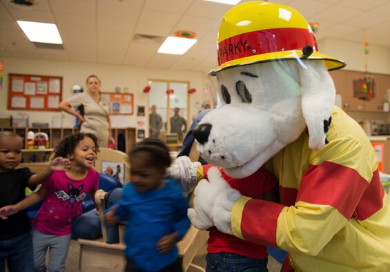 Sparky the Fire Dog hugs children at the Child Development Center at Moody Air Force Base Ga., Oct. 10, 2012. Sparky also visited children at local elementary schools to help educate them on fire prevention. (U.S. Air Force photo by Senior Airman Douglas Ellis/Released)
