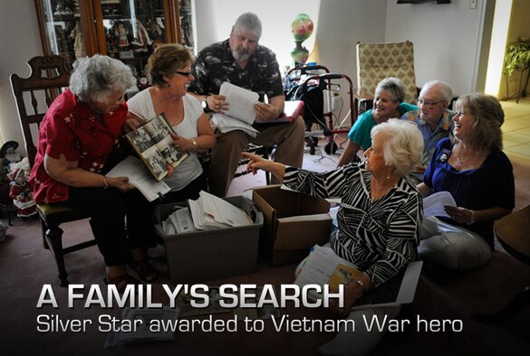 Relatives laugh as Debra Morris, second from left, a niece of the late U.S. Air Force Master Sgt. James Calfee, shows a photo of her uncle from his high school yearbook in Houston, Texas, Aug. 22, 2012. Calfee, who was posthumously awarded the Silver Star Medal, was killed in action in Laos in 1968. (U.S. Air Force photo/Val Gempis)