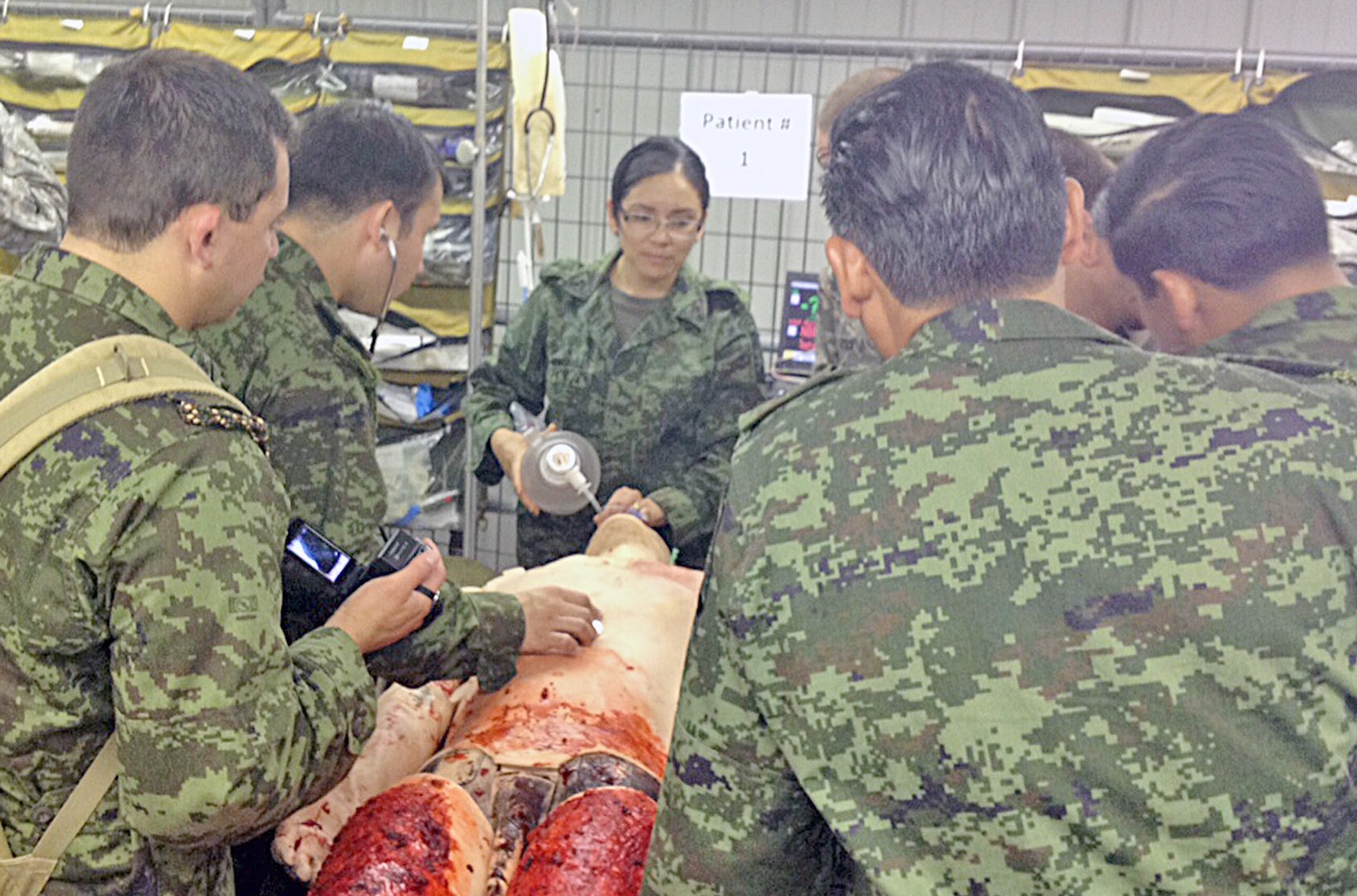 Mexican army Maj. Carina Castro (center), an anesthesiologist with the Mexican army’s medical officers corps, leads her fellow medical officers through a procedure while observing training Sept. 19 at Joint Base San Antonio-Camp Bullis.
Photo by Maj. Jim Marckwardt