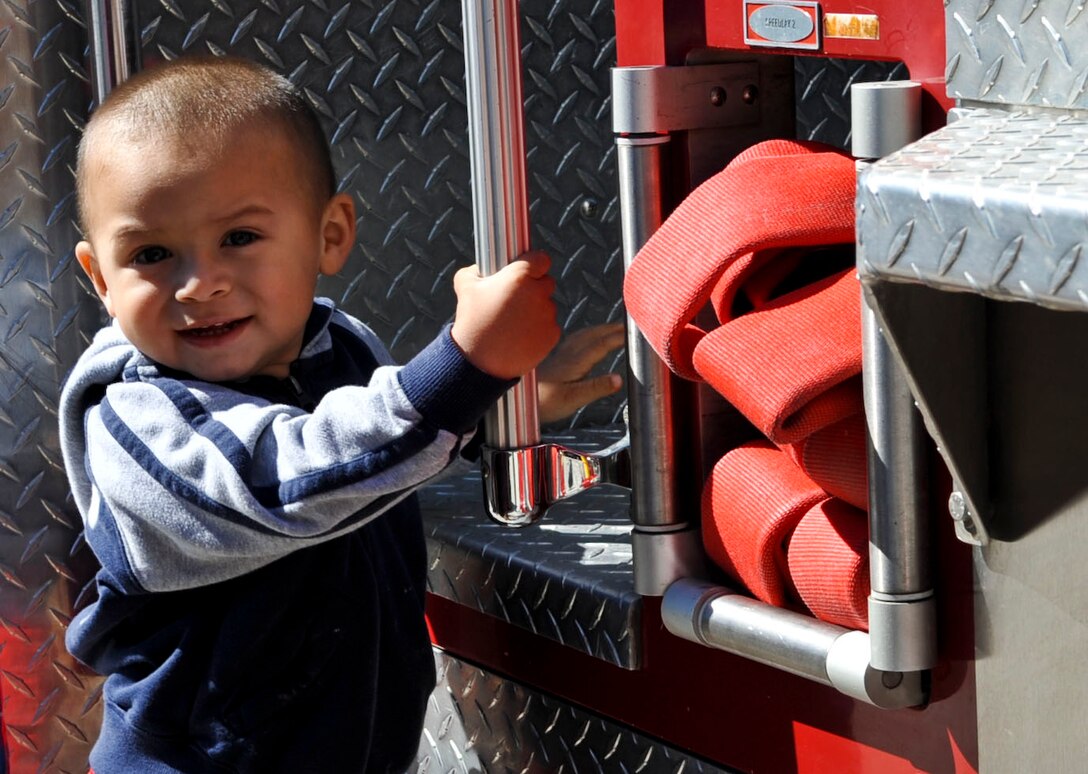 Two-year-old Isaiah Ruvalcaba climbs on a fire truck at the Fort Eustis Fire Department open house as part of Fire Prevention Week at Fort Eustis, Va., Oct. 13, 2012. Isaiah was one of many children who attended the event and were able to enjoy the fire trucks and ambulances on display. (U.S. Air Force photo by Staff Sgt. Wesley Farnsworth / Released)