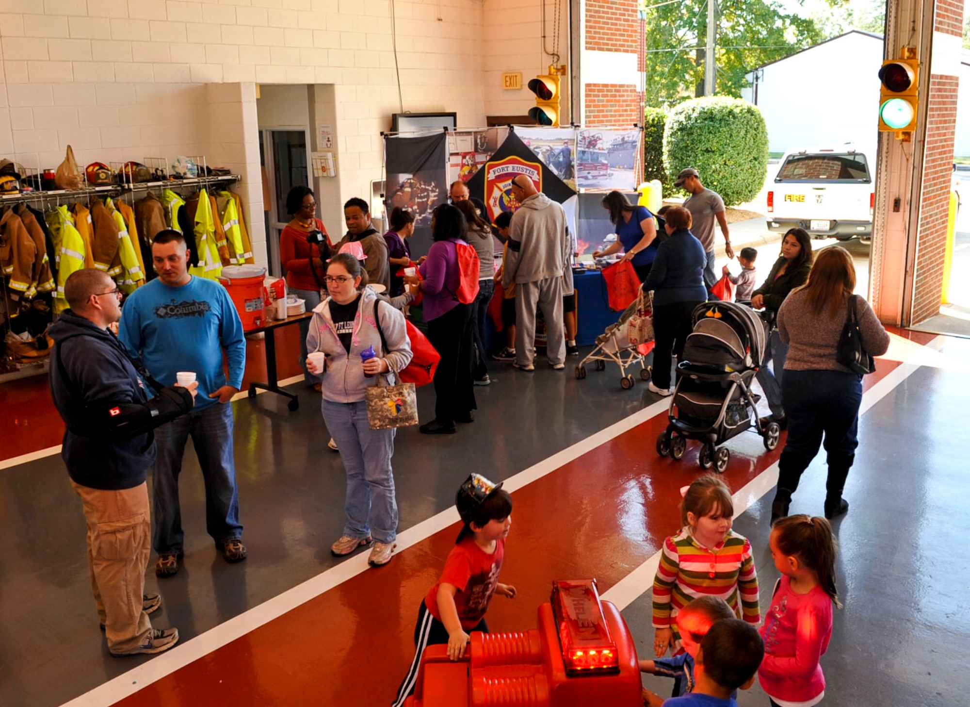 Residents of Fort Eustis attend their Fire Departments open house as part of Fire Prevention Week at Fort Eustis, Va., Oct. 13, 2012. Visitors were able to climb in and on fire trucks and ambulances, as well enjoy a variety of other events. (U.S. Air Force photo by Staff Sgt. Wesley Farnsworth / Released) 