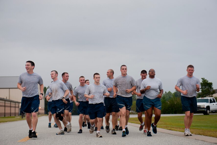 Members of the 820th Base Defense Group rally to help an Airman complete the last leg of a one-mile run during the annual LeeBernard Chavis Memorial Workout Oct. 15, 2012, at Moody Air Force Base, Ga. The workout consists of 150 burpees, a one-mile run and 150 squat thrusts. Since 2008, the workout has spread to other bases as a way to remember Chavis’ sacrifice. (U.S. Air Force photo by Staff Sgt. Jamal D. Sutter/Released)   
