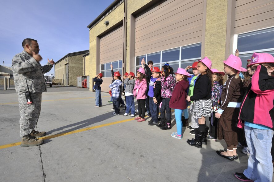 Tech Sgt. Andres Steevens, 92nd Civil Engineer Squadron lead firefighter, speaks with children from Michael Anderson Elementary school outside of the Fairchild Air Force Base fire department Oct. 8. 2012.  Steevens spoke with the students about the different fire trucks and some of their capabilities in case of an emergency. (U.S. Air Force Photo by Airman 1st Class Mary O'Dell)