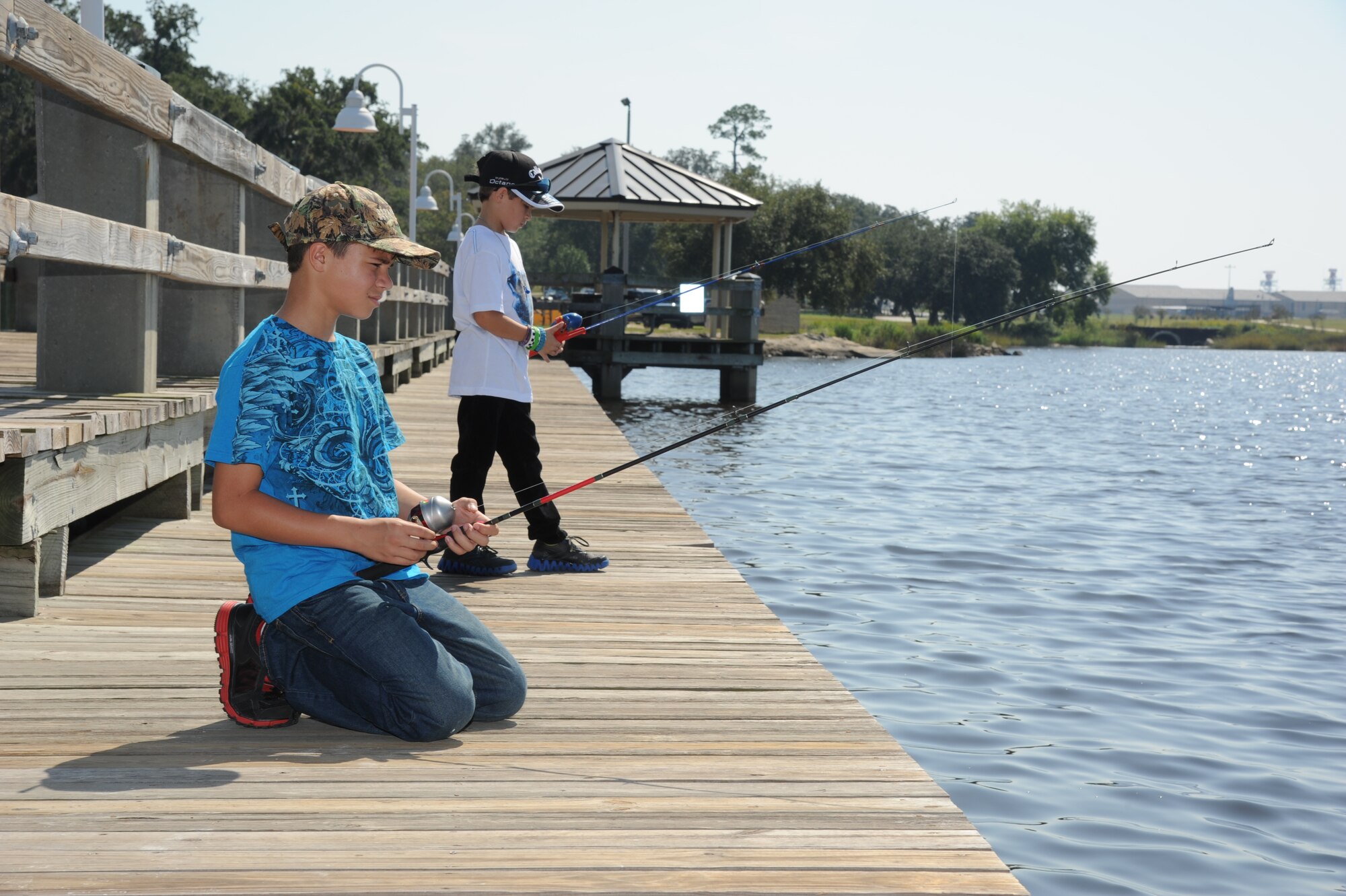 Jordan McDevitt, 11, and his brother, Jayden, 8, attempt to catch fish during the Kids Fall Fishing Rodeo Oct. 13, 2012, at the Keesler Marina, Keesler Air Force Base, Miss.  Jordan and Jayden’s grandparents are Ruth and retired Master Sgt. Randall Adams of D’Iberville, Miss.  (U.S. Air Force photo by Kemberly Groue)