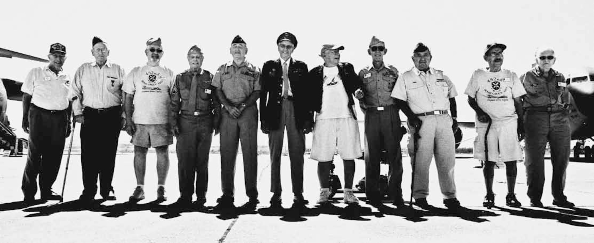 Poised between the C-17 Globemaster III and a KC-135 Stratotanker, members of the 452nd Bombardment Group stand together as they once did 60 years ago, but without their B-17, Sep. 8. This group was awarded the Distinguished Service Award, later known as the Presidential Citation, for their actions during a bombing campaign over Kaltenkirchen, Germany, where they delivered more than 176,000 pounds of bombs, crippling the German Air Force. (U.S. Air Force photo by Master Sgt. Carson Hampton)