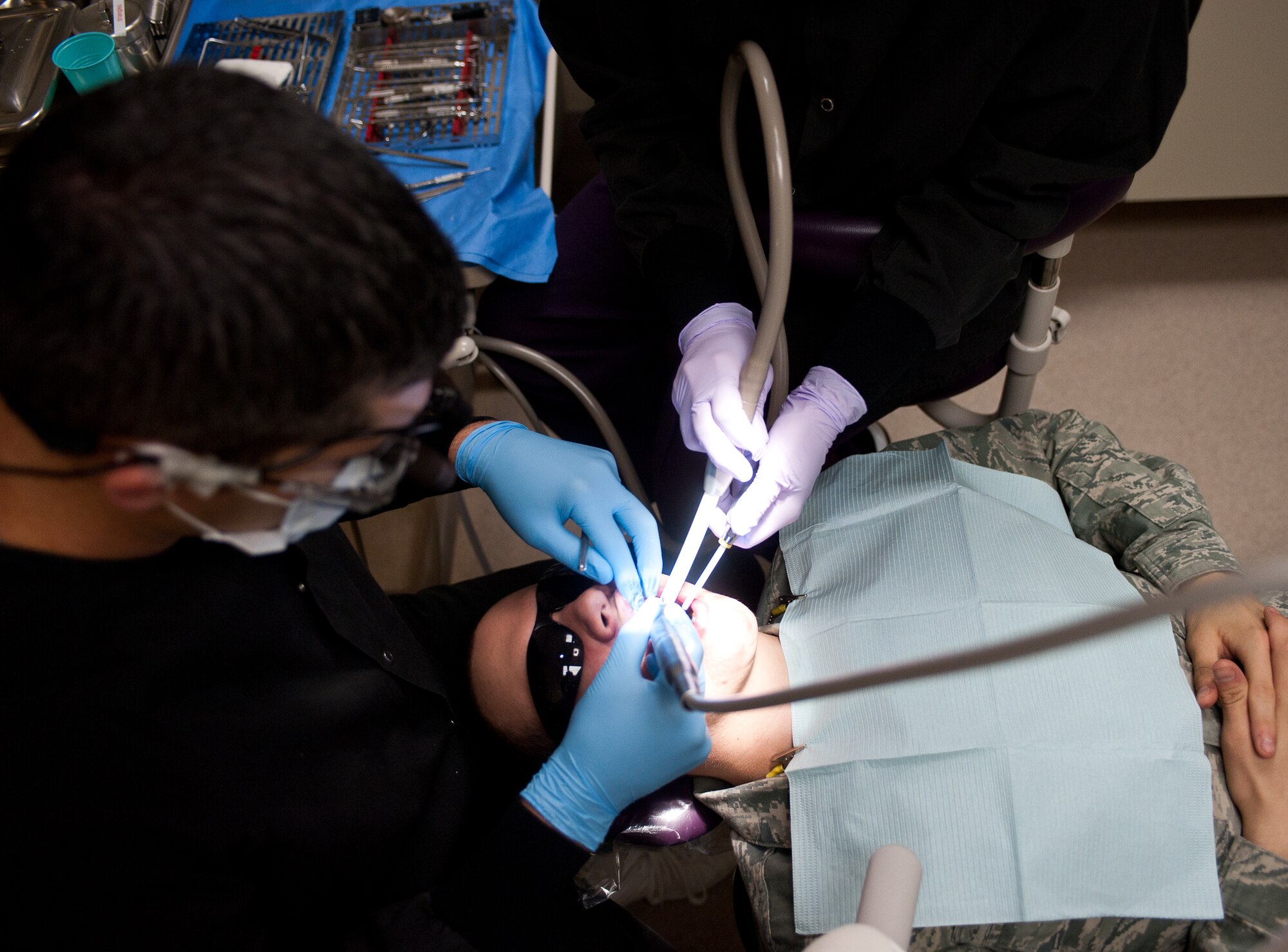 Capt. Damon Pope, 28th Medical Operations Squadron dentist, performs an oral examination during an annual checkup at the dental clinic at Ellsworth Air Force Base, S.D., Oct. 11, 2012. Airmen are required to receive a professional teeth cleaning once a year to ensure they stay healthy and maintain deployment readiness. (U.S. Air Force by Airman 1st Class Alystria Maurer/Released)