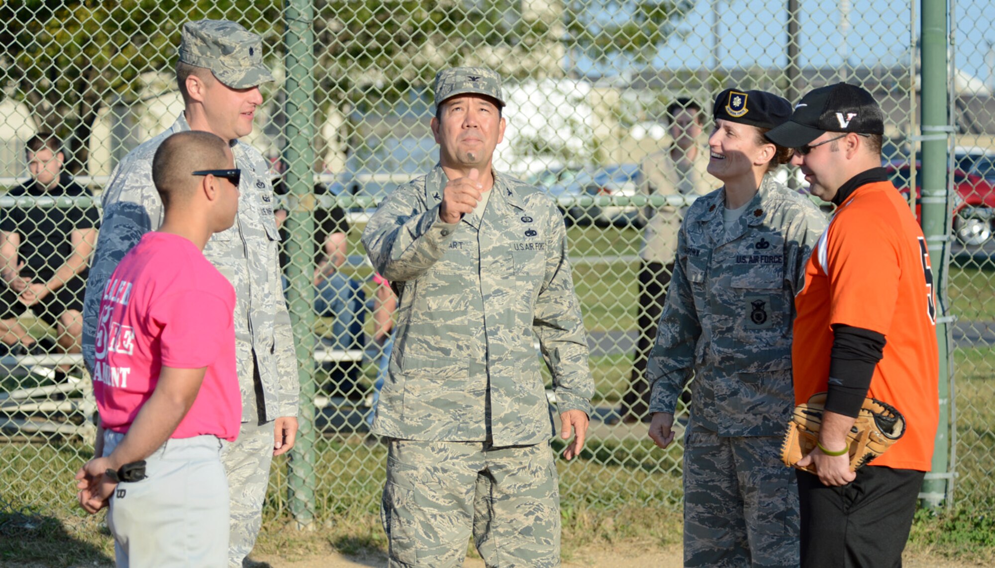 Col. Thomas Reppart, 436th Mission Support Group commander, tosses a coin to determine the home and visiting teams before the Battle of the Badges softball game between the 436th Security Forces Squadron and the 436th Civil Engineer Squadron Fire Department Oct. 10, 2012, at the softball field on Dover Air Force Base, Del. The coin toss would prove to be the only thing the Fire Dawgs would win, as the Cops blew them out 18-3. (U.S. Air Force photo by Tech. Sgt. Chuck Walker)