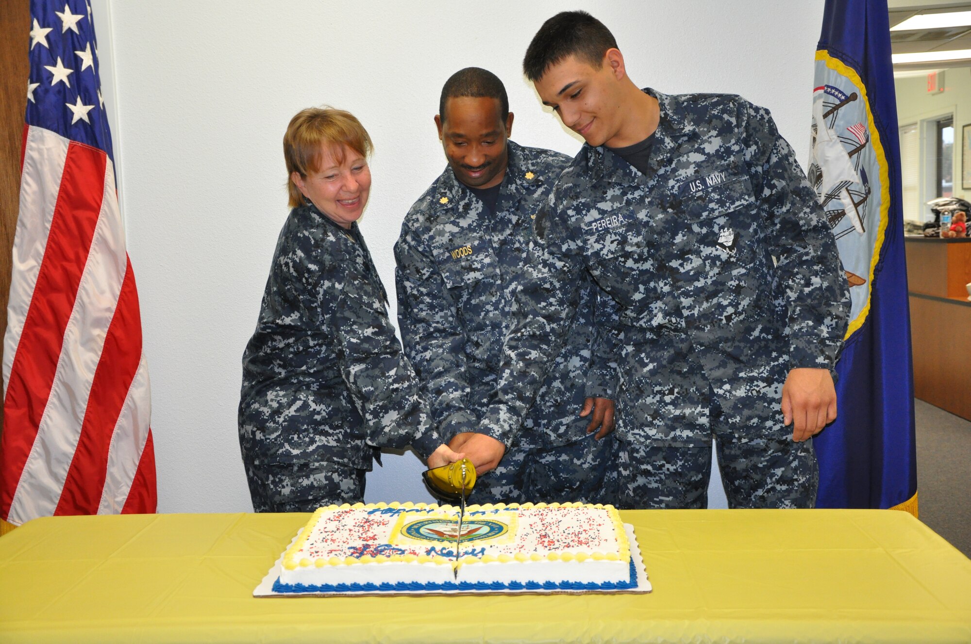 GOODFELLOW AIR FORCE BASE, Texas-From the left, Navy Chief Petty Officer Carol J. Yoakum, Center for Information Dominance Detachment information dominance specialist, Lt. Commander Cornell Woods, Center for Information Dominance Detachment officer-in-charge, and Seaman Andre Pereiria,  Center for Information Dominance  Detachment student, cut the cake at the celebration of the Navy’s 237th birthday Oct. 12, here.  Traditionally, the oldest and the youngest sailors in attendance, along with the commander, cut the birthday cake. (U.S. Air Force photo/ Airman 1st Class Erica Rodriguez)