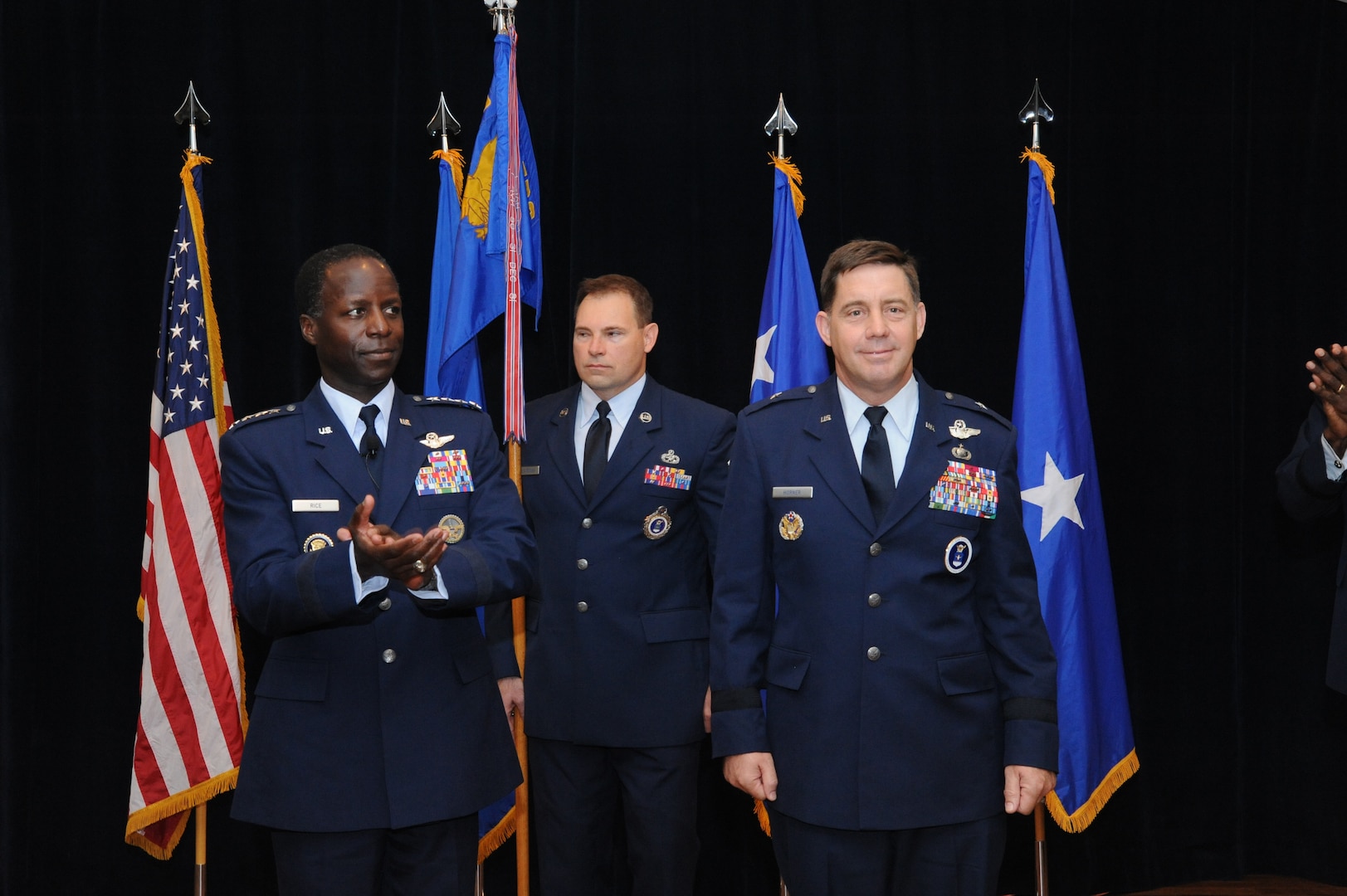 General Edward Rice (left), Air Education and Training Command commander, presided over the Air Force Recruiting Service change of command ceremony at the Joint Base San Antonio-Randolph enlisted club Oct. 11. Brig. Gen. John Horner (right) succeeded Brig. Gen. Balan R. Ayyar (not pictured) as AFRS commander. Chief Master Sgt. William Cavenaugh (middle), AFRS command chief, presented the guidon during the ceremony. (U.S. Air Force photo/Richard McFadden)