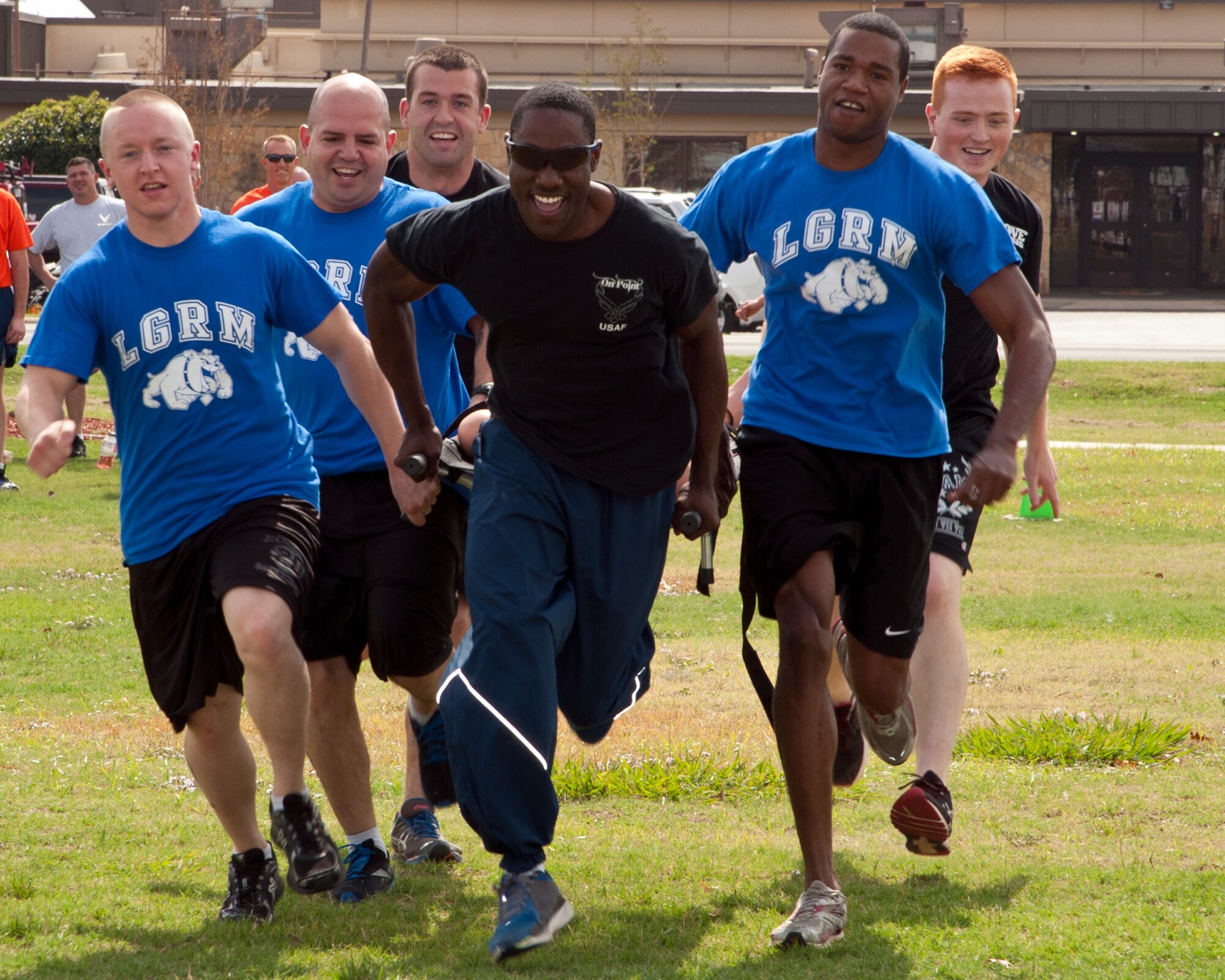 ALTUS AIR FORCE BASE, Okla. -- Airmen from the 97th Logistics Readiness Squadron material management flight participate in the Rescue Randy race as part of the Fire Prevention Week Muster at Wings of Freedom Park, Oct. 12, 2012. The Muster events were made to simulate some of the challenges firefighters experience during emergency situations. Fire Prevention Week is held annually to promote fire safety and prevention through activities and demonstrations held throughout the base. (U.S. Air Force photo by Senior Airman Kenneth W. Norman / Released)