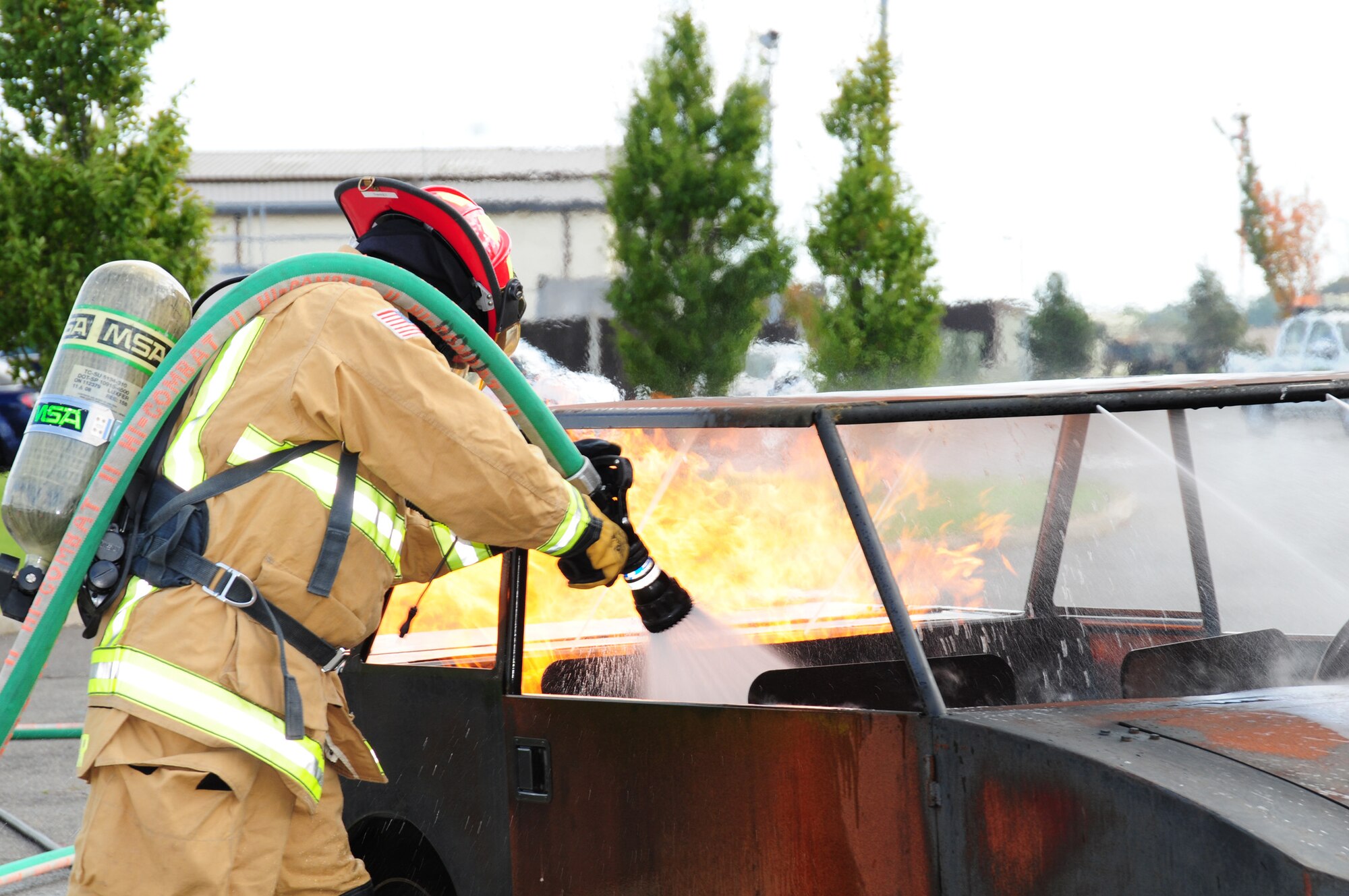 Master Sgt. Matthew Luetkemeyer, 100th Civil Engineer Squadron Fire Department, puts out a vehicle fire during a demonstration at the fire department’s open house Oct. 12, 2012, at RAF Mildenhall, England. The demonstration was one of several held for Fire Prevention Week. (U.S. Air Force photo by Karen Abeyasekere/Released)