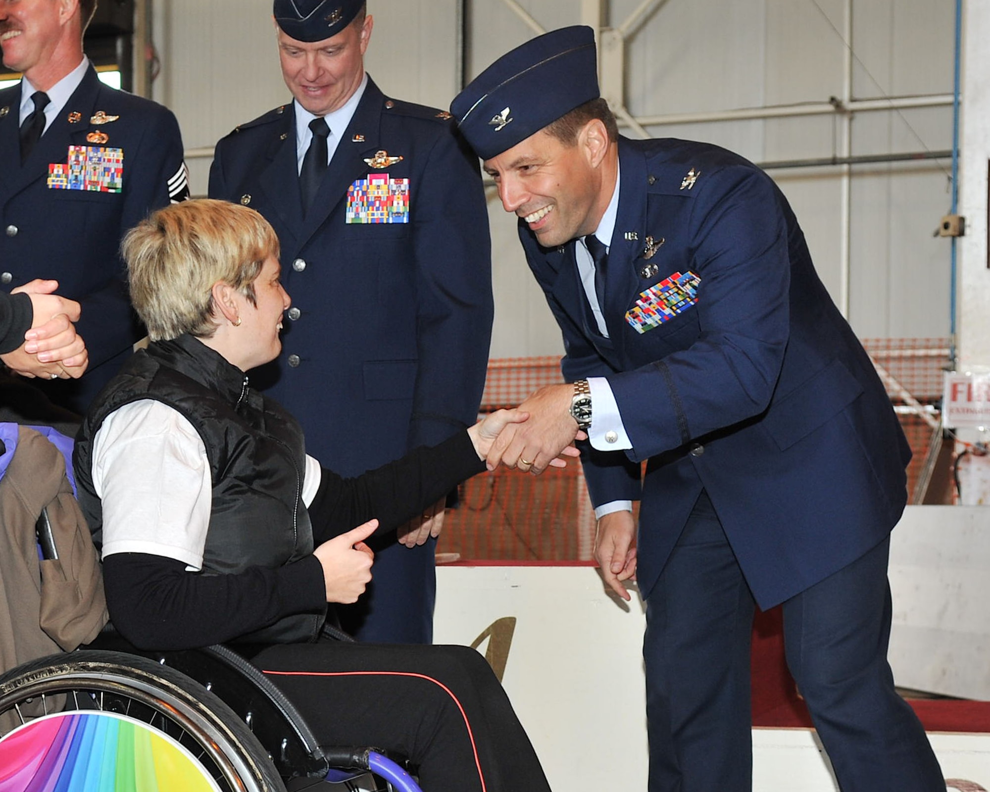 Col. Christopher Kulas, 100th Air Refueling Wing commander, greets participants of Joan Mann Special Sports Day during the Parade of Champions Oct. 13, 2012, at RAF Mildenhall, England. Kulas and other members of the 100th ARW joined volunteers from RAF Lakenheath, RAF Feltwell and RAF Alconbury for the event, which hosted more than 200 special athletes from the local area. (U.S. Air Force photo by Senior Airman Jerilyn Quintanilla/Released) 