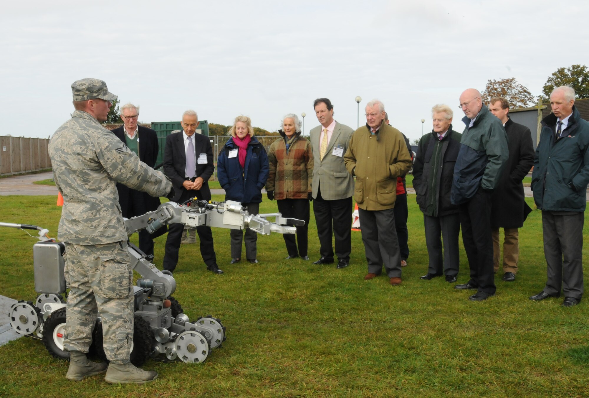 Senior Airman Robert McNaught, 48th Civil Engineer Squadron explosive ordnance disposal technician, demonstrates an explosive ordnance disposal robot for members of a community relations tour Oct. 12, 2012, at RAF Feltwell, England. The high sheriffs of several counties, their spouses and several other distinguished guests visited RAF Mildenhall, RAF Lakenheath and RAF Feltwell during the tour, which was hosted by U.S. Air Forces in Europe - United Kingdom. (U.S. Air Force photo by Tech. Sgt. Neal X. Joiner/Released) 