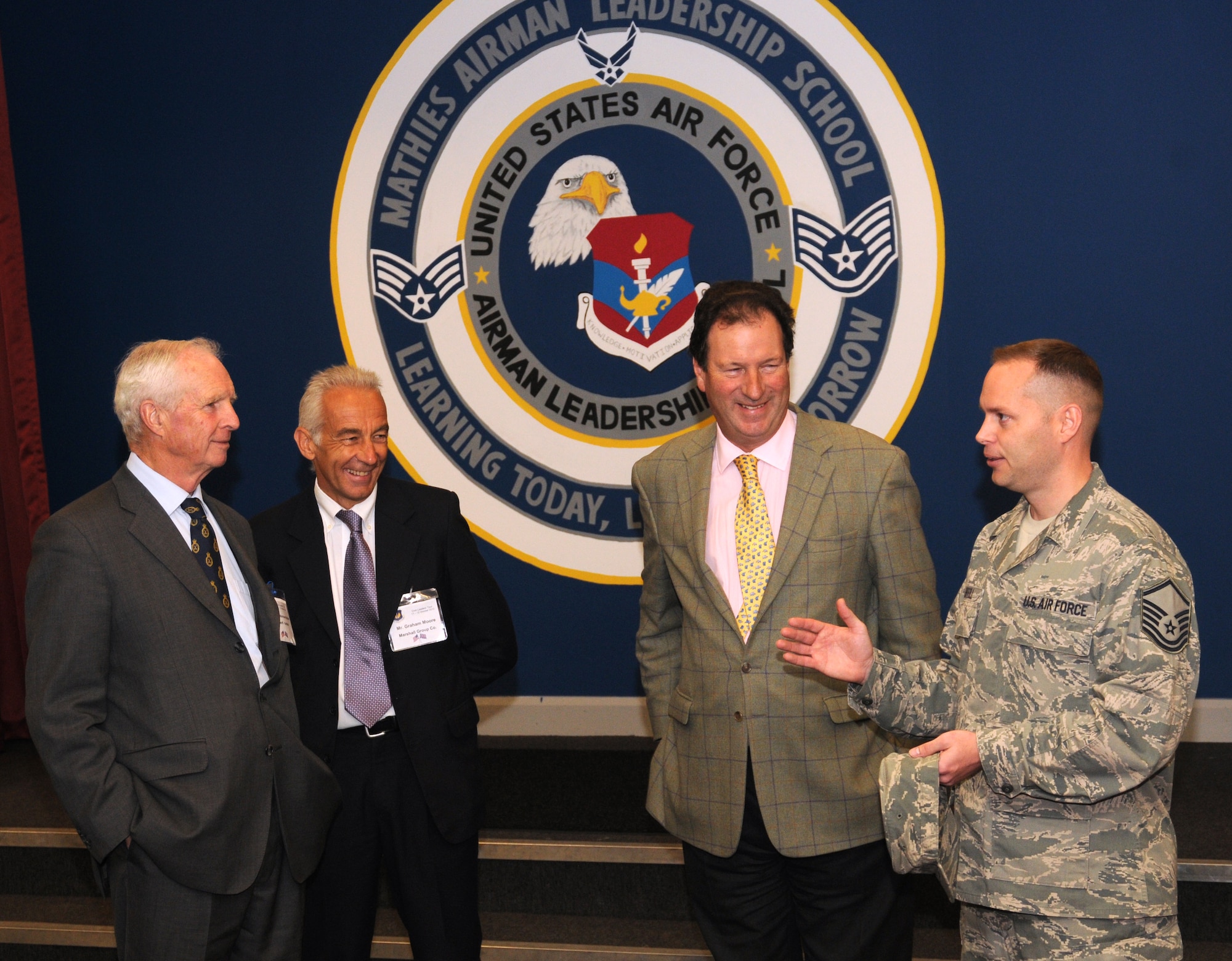 Master Sgt. Steven Saffell, Mathies Airman Leadership School commandant, speaks with, from left, Andrew Norman-Butler, the High Sheriff of Suffolk; Graham Moore, Marshall Group Company marketing executive; and Henry Cator, High Sheriff of Norfolk, during a community relations tour Oct. 12, 2012, at RAF Feltwell, England. The tour group was hosted by U.S. Air Forces in Europe - United Kingdom and consisted of the high sheriffs of several counties, their spouses and several other distinguished guests. The tour group visited RAF Mildenhall, RAF Lakenheath and RAF Feltwell. (U.S. Air Force photo by Tech. Sgt. Neal X. Joiner/Released)