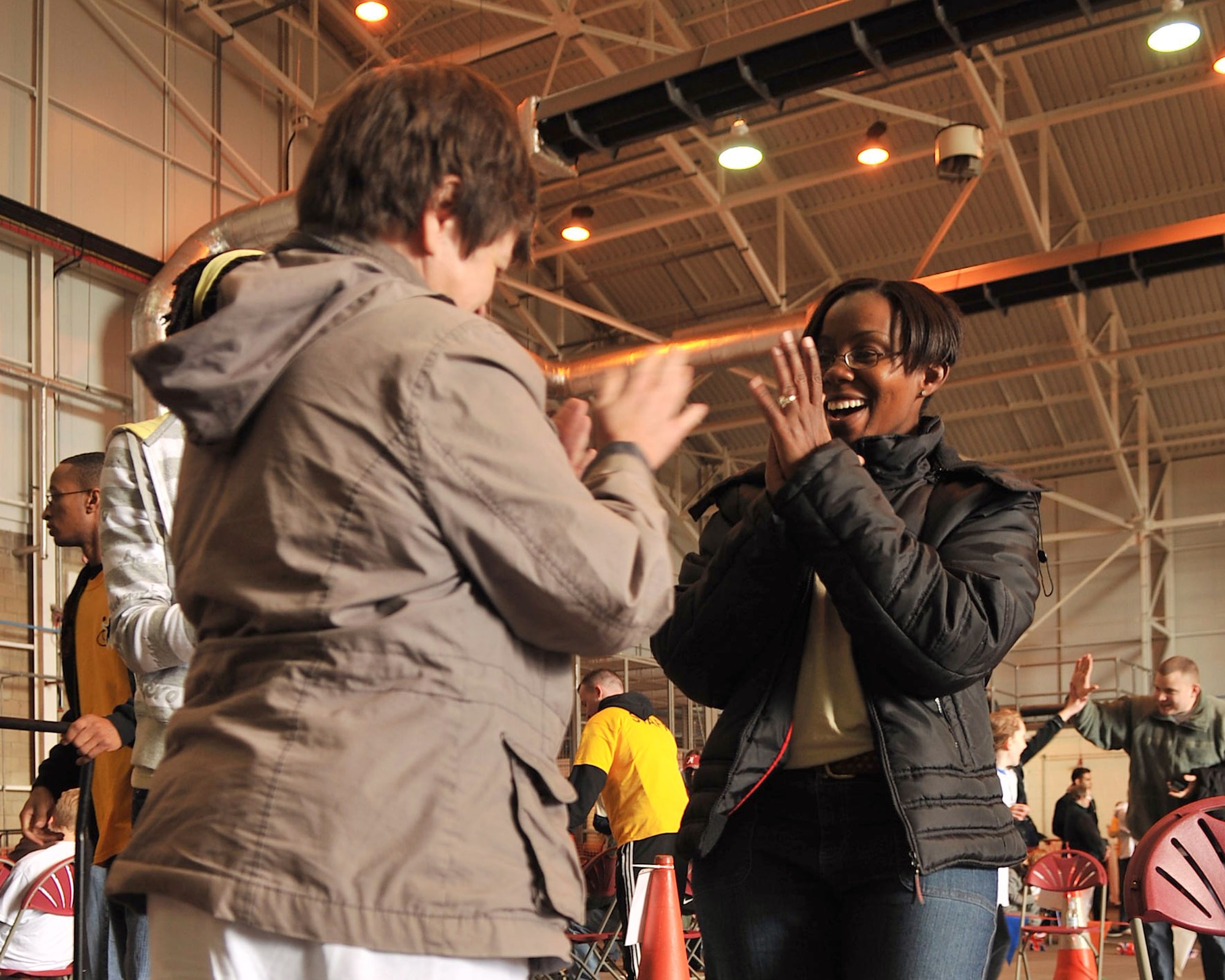 Tech. Sgt. Maria Simpson, 501st Combat Support Wing Equal Opportunity office, cheers along with a special athlete participating in Joan Mann Special Sports Day Oct. 13, 2012, at RAF Mildenhall, England. Simpson was one of more than 800 Airmen who volunteered to support the event. (U.S. Air Force photo by Senior Airman Jerilyn Quintanilla/Released)
